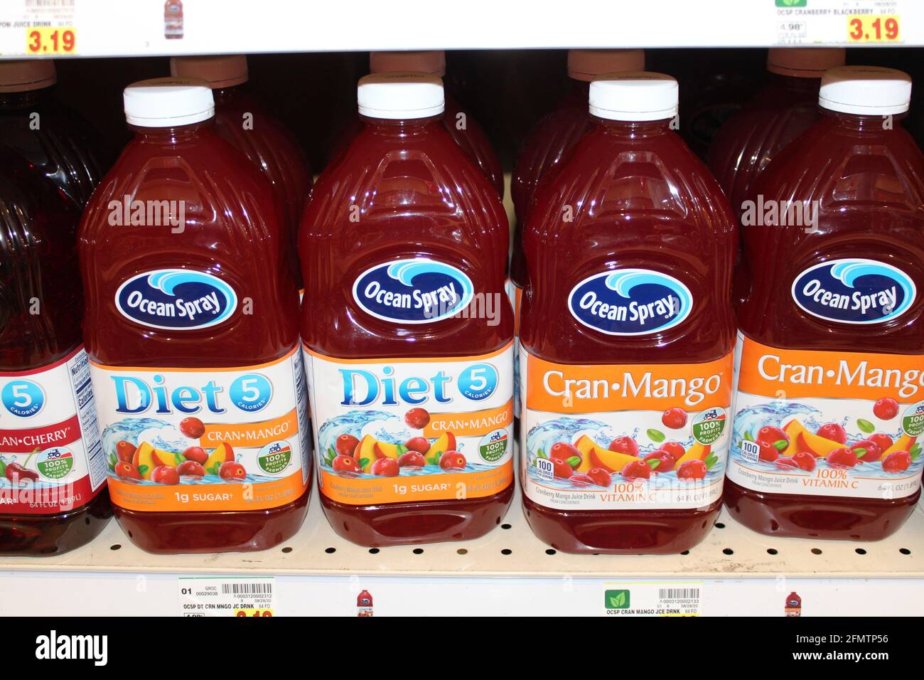 Ocean Spray Juice shot closeup on a metal shelf at a grocery store in Kansas that's bright and colorful in plastic containers. Stock Photo