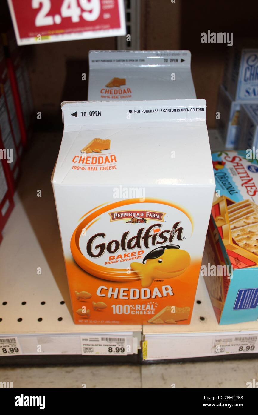 Pepperidge Farm Gold Fish cheddar crackers shot closeup  on a metal shelf at a grocery store in Kansas that's bright and colorful. Stock Photo