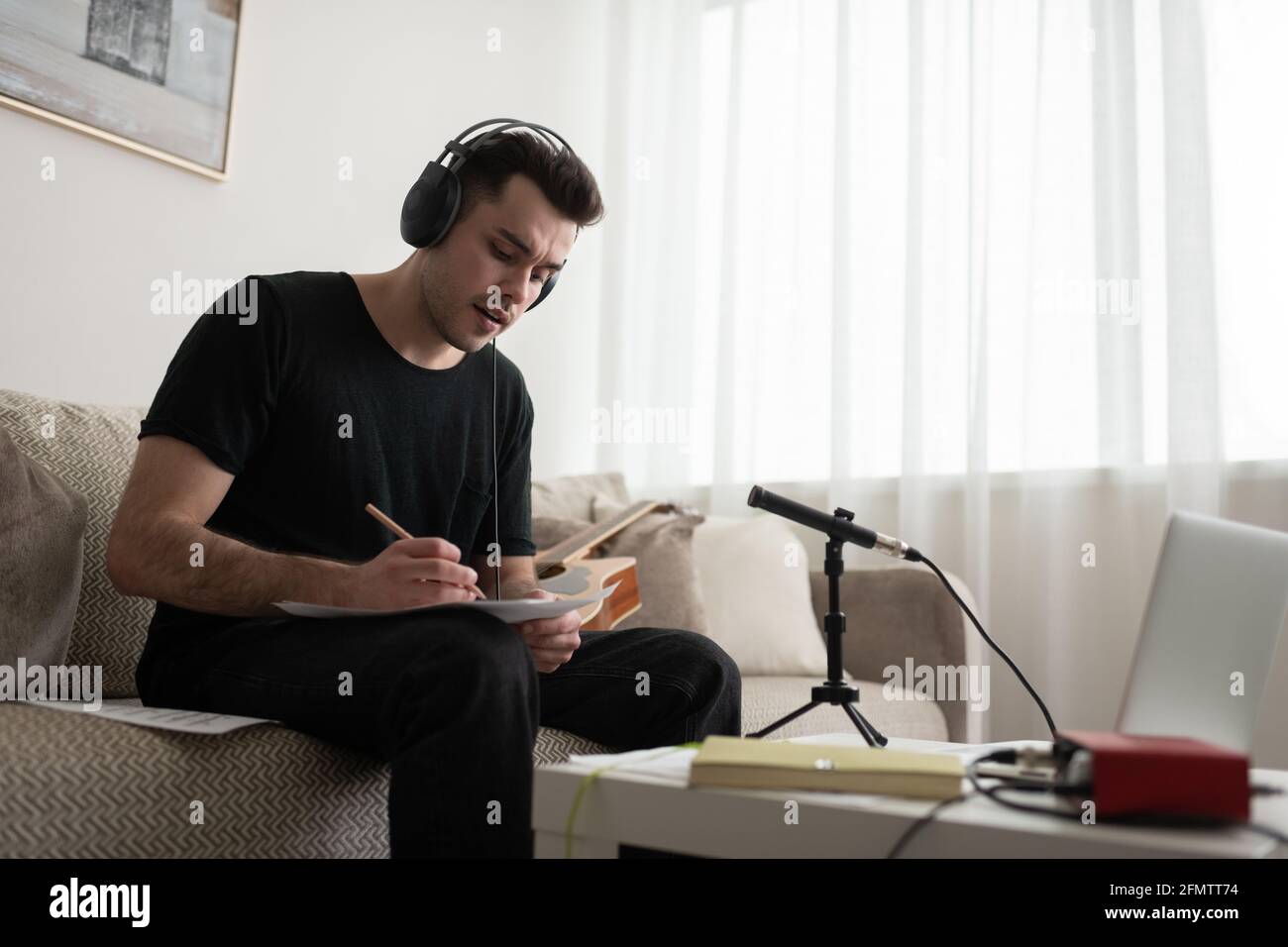 Male musician composing music at home Stock Photo