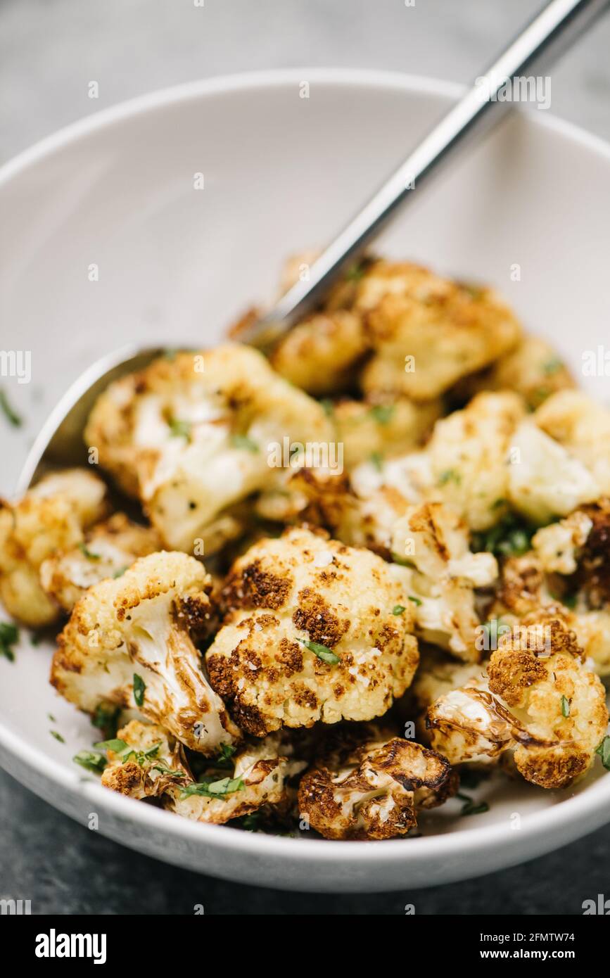 Close-up photo of fried cauliflower topped with parsely Stock Photo