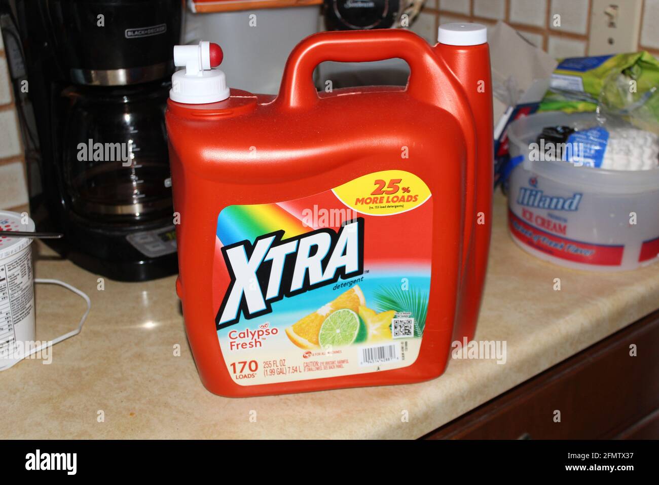 Xtra Laundry detergent that's bright and colorful on a counter top shot