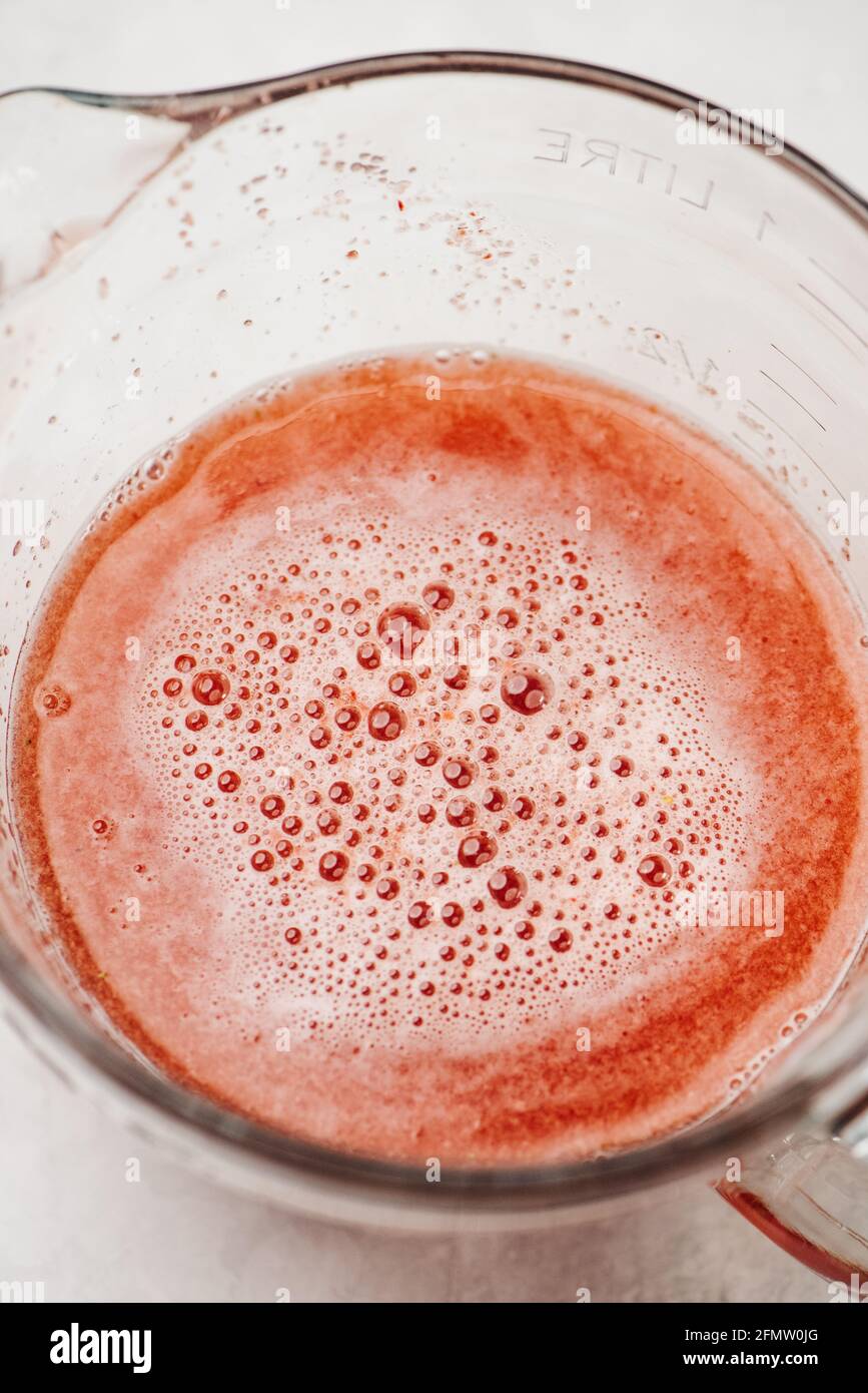 Fresh made strawberry juice with bubble froth Stock Photo