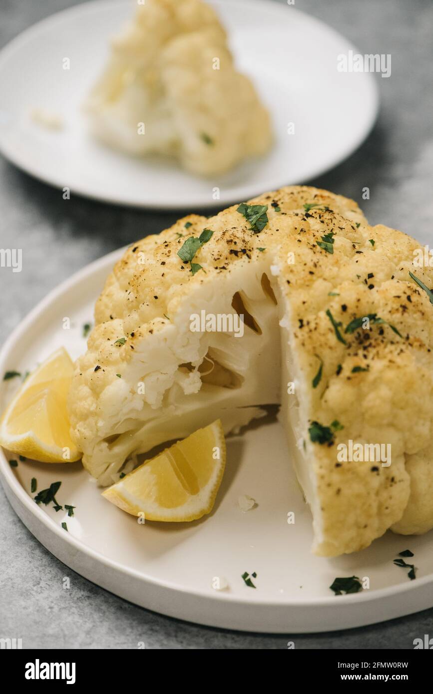Head of roasted cauliflower with a wedge removed Stock Photo