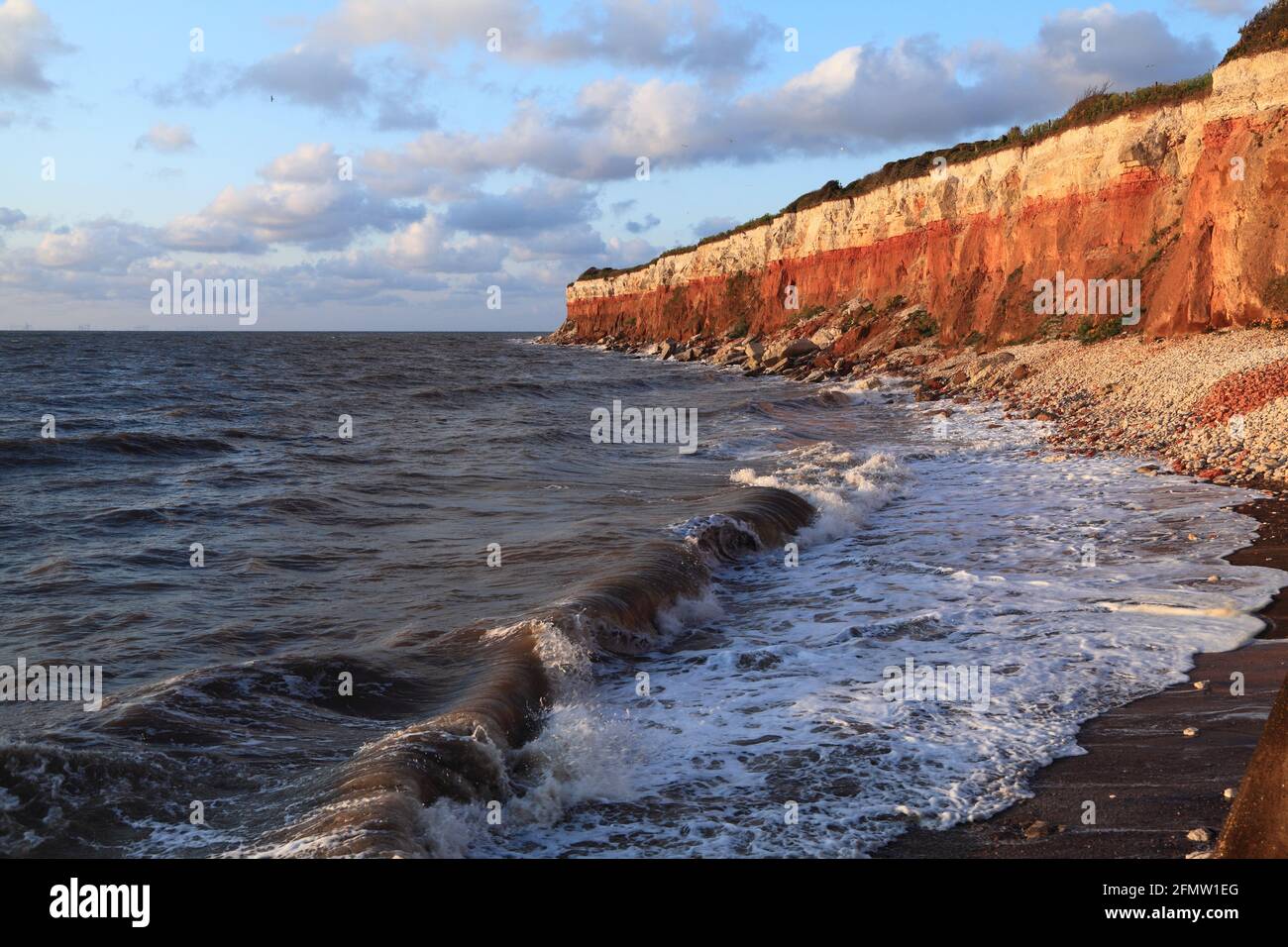 Old Hunstanton cliffs, striped, high tide, waves, Norfolk, England Stock Photo