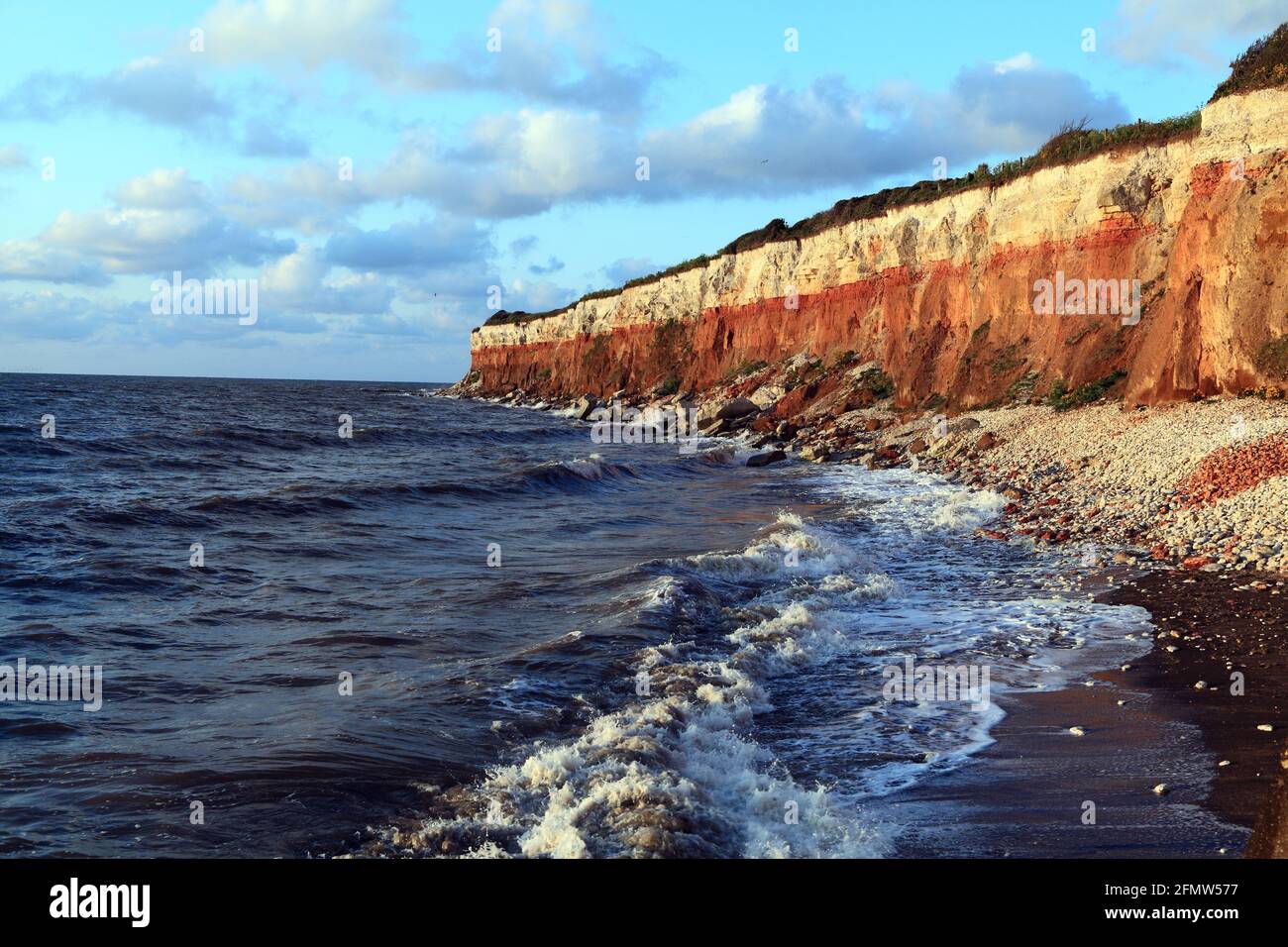 Old Hunstanton cliffs, striped, high tide, waves, Norfolk, England Stock Photo