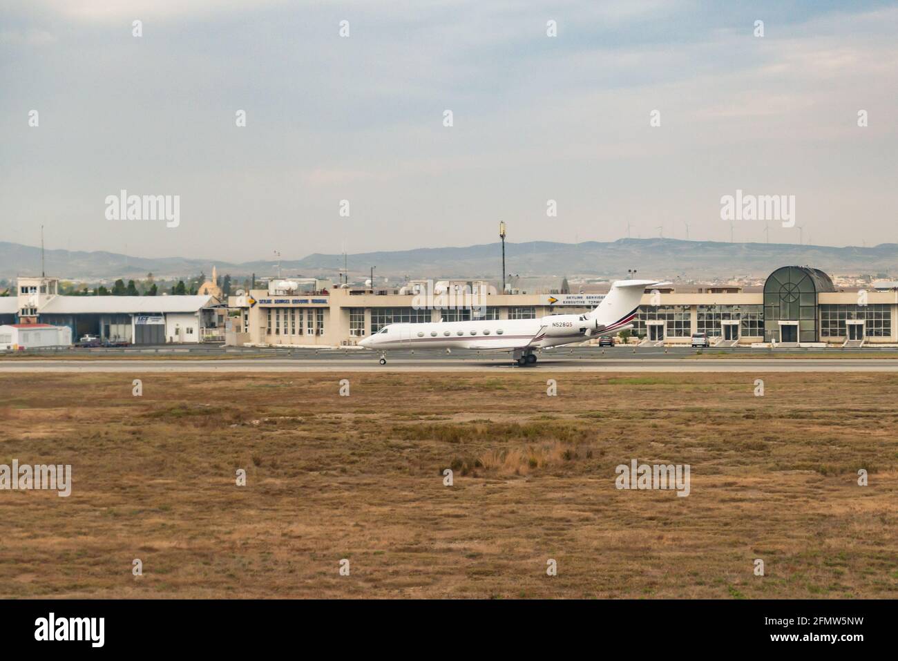 Paphos Airport in Cyprus. Planes on the runway and at the hangars