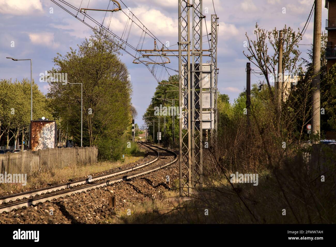 Railway tracks next to railroad crossing in an italian town Stock Photo ...