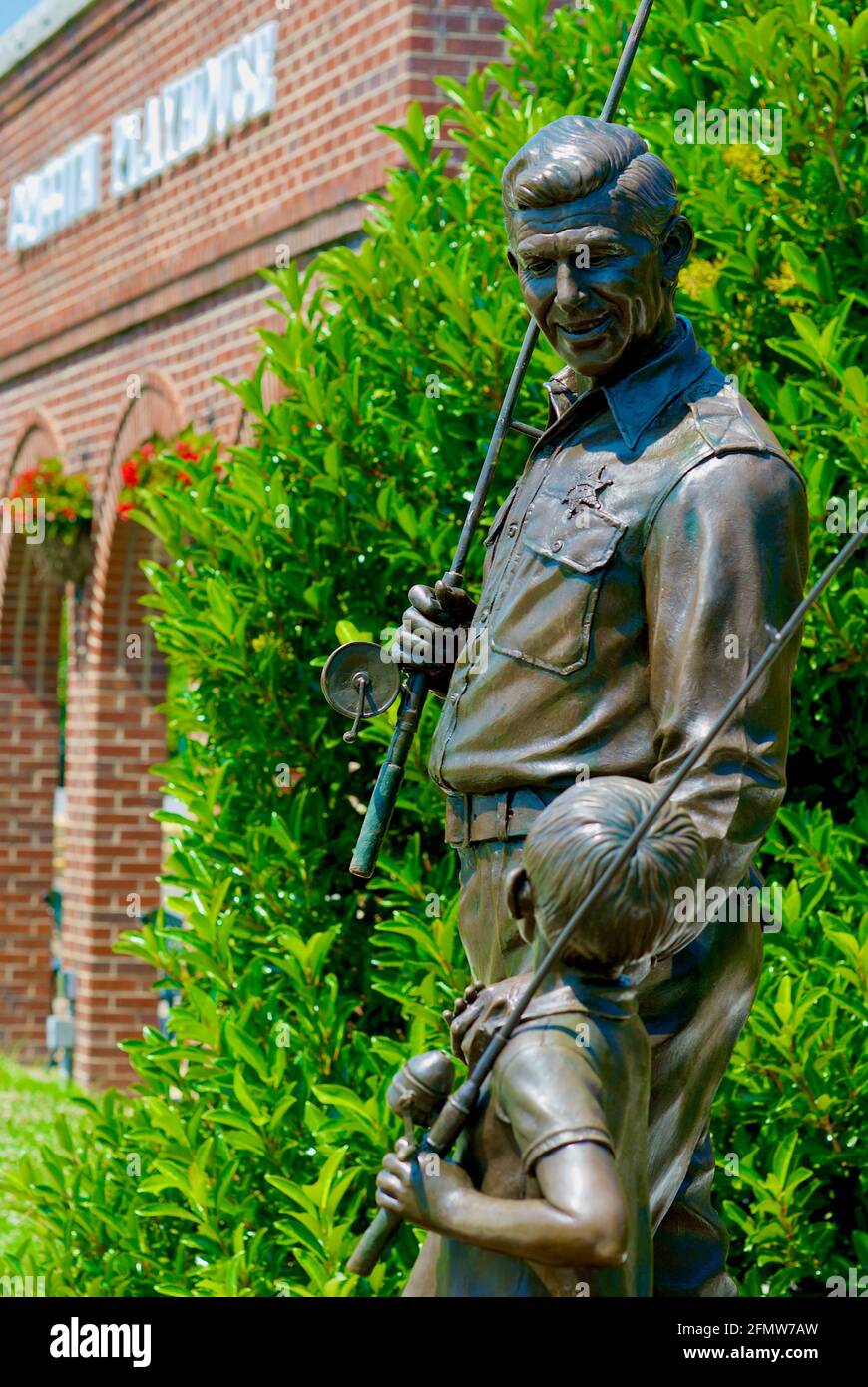 Mount Airy, North Carolina, USA - July 5, 2020: A bronze statue commemorates 'Sheriff Andy and Opie Taylor' of the popular 'The Andy Griffith Show'. Stock Photo