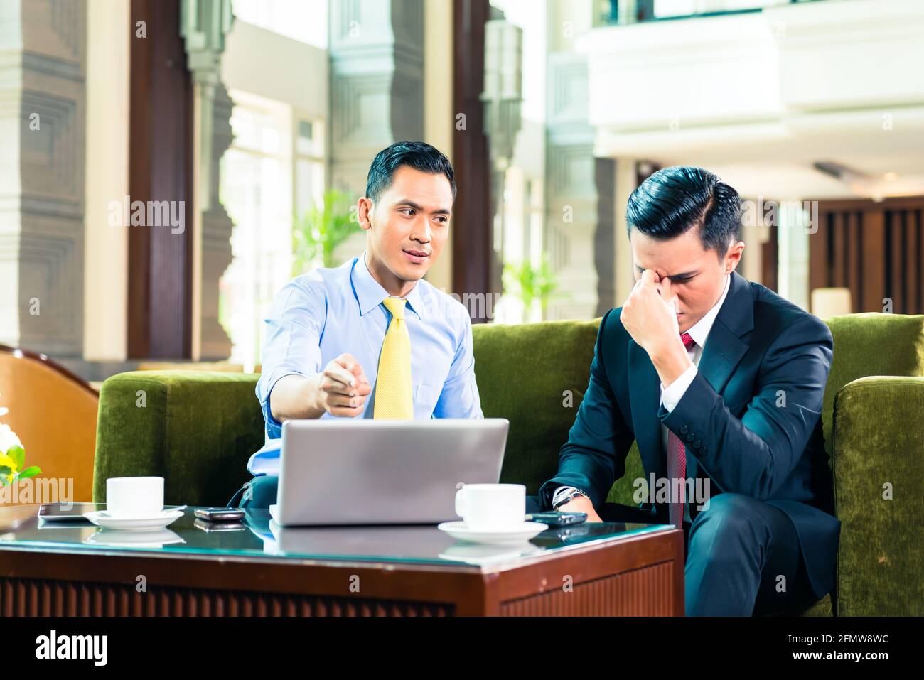 Asian Businessman thinking while having a meeting Stock Photo