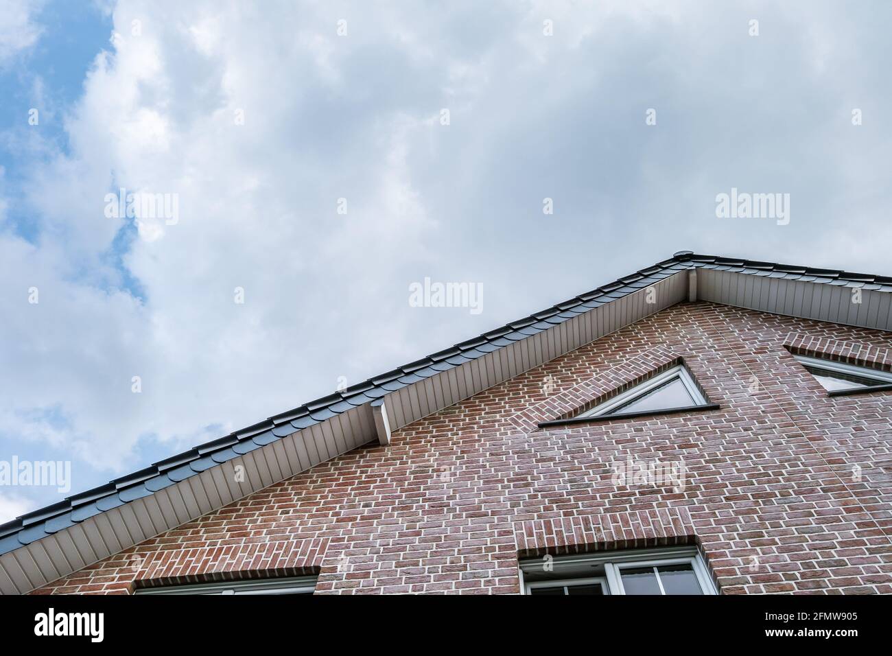 Low angle of an old brick-walled house under a cloudy sky Stock Photo ...