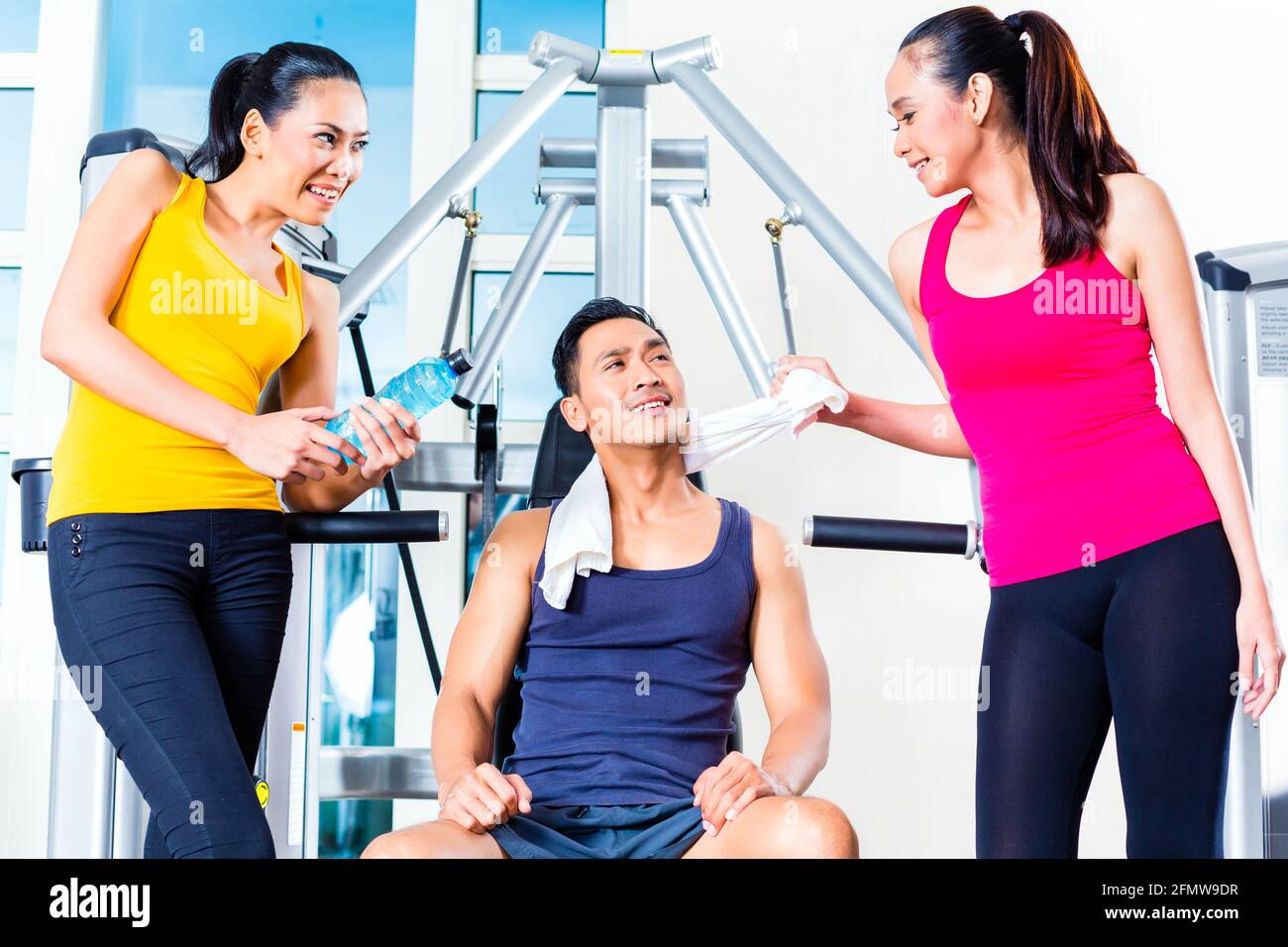 Women Teasing Man At Gym Stock Photo Alamy