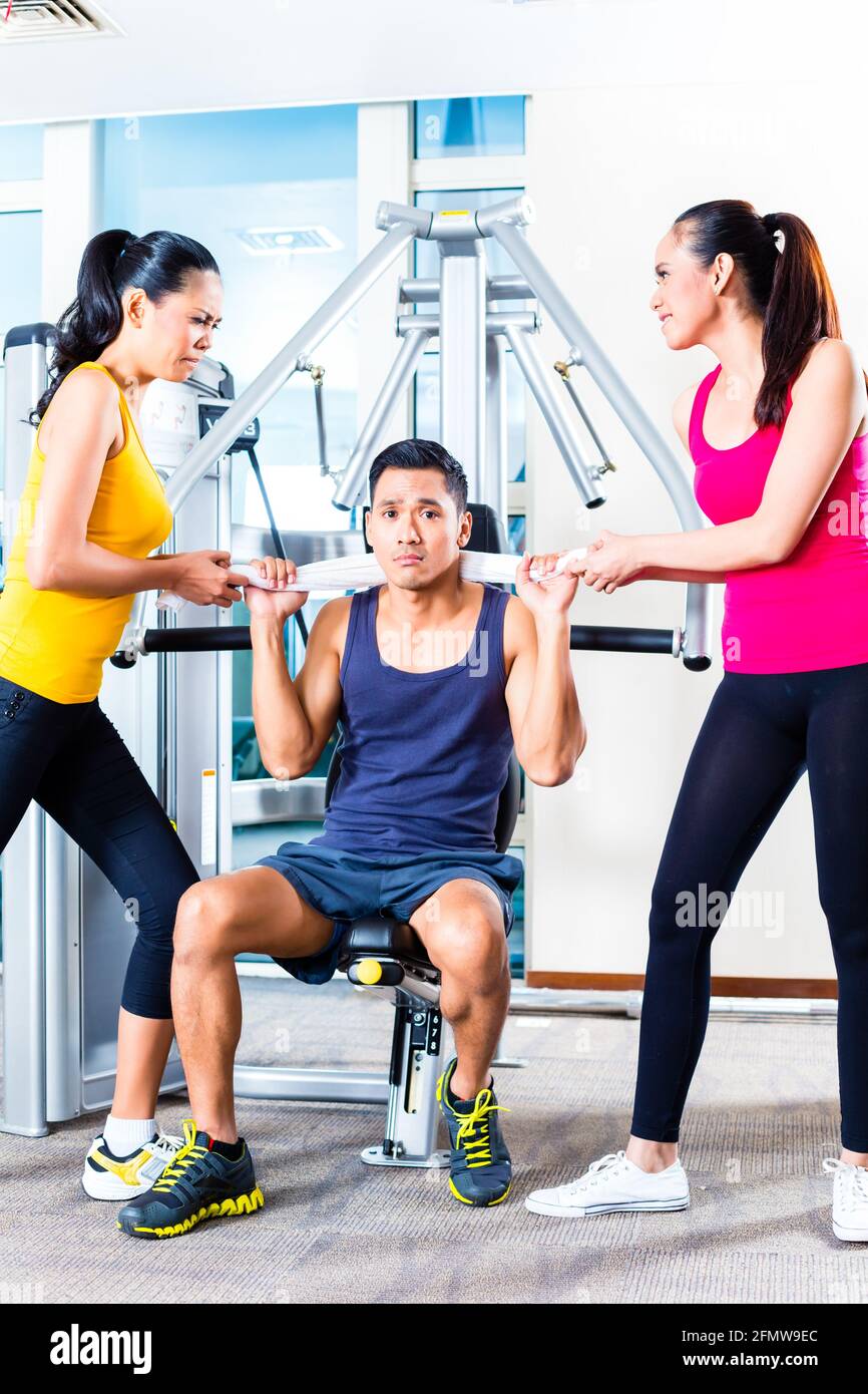 Women fighting over man at gym Stock Photo Alamy