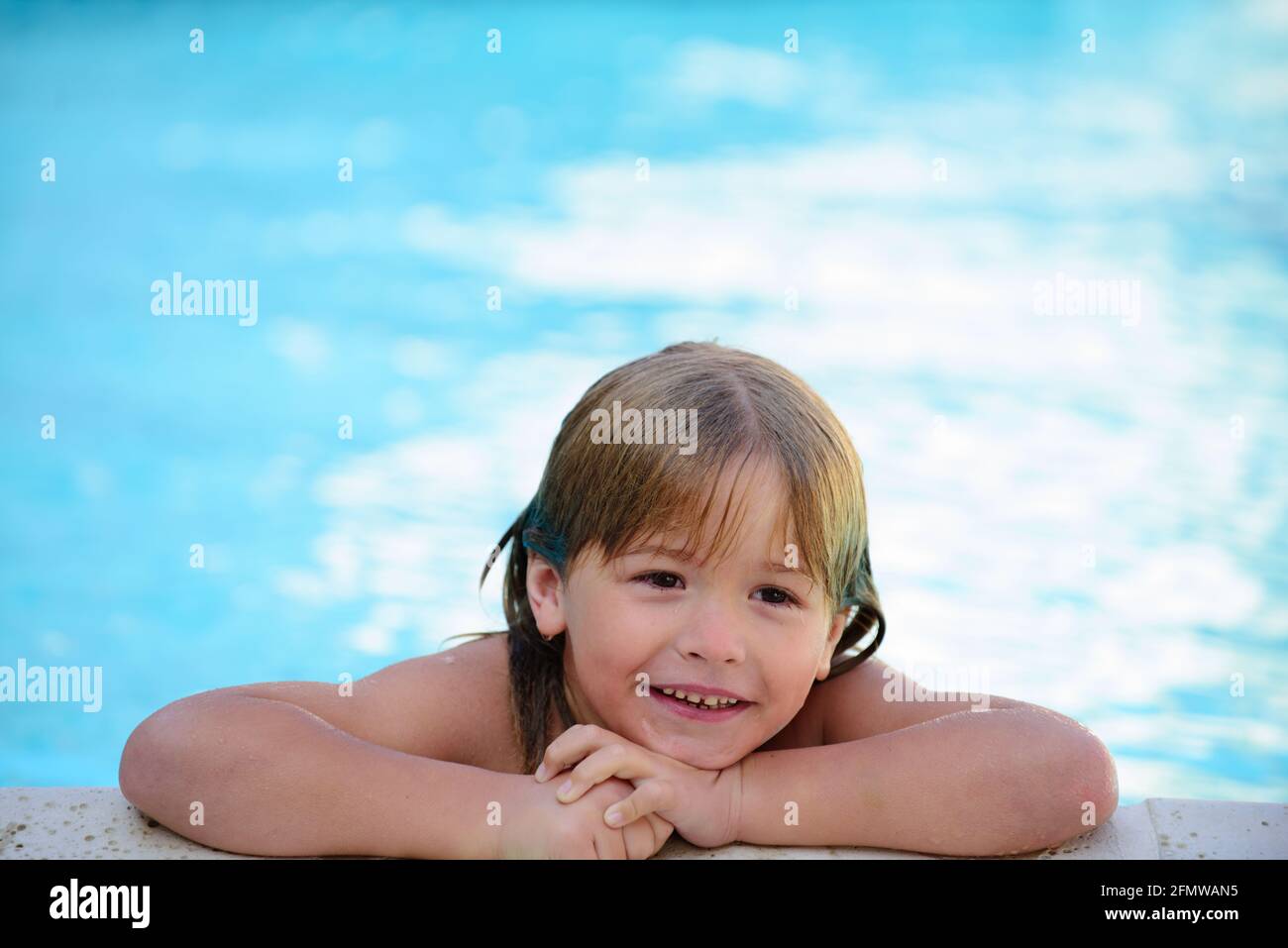Child in summer pool. Pool resort. Summer weekend. Smilling boy at