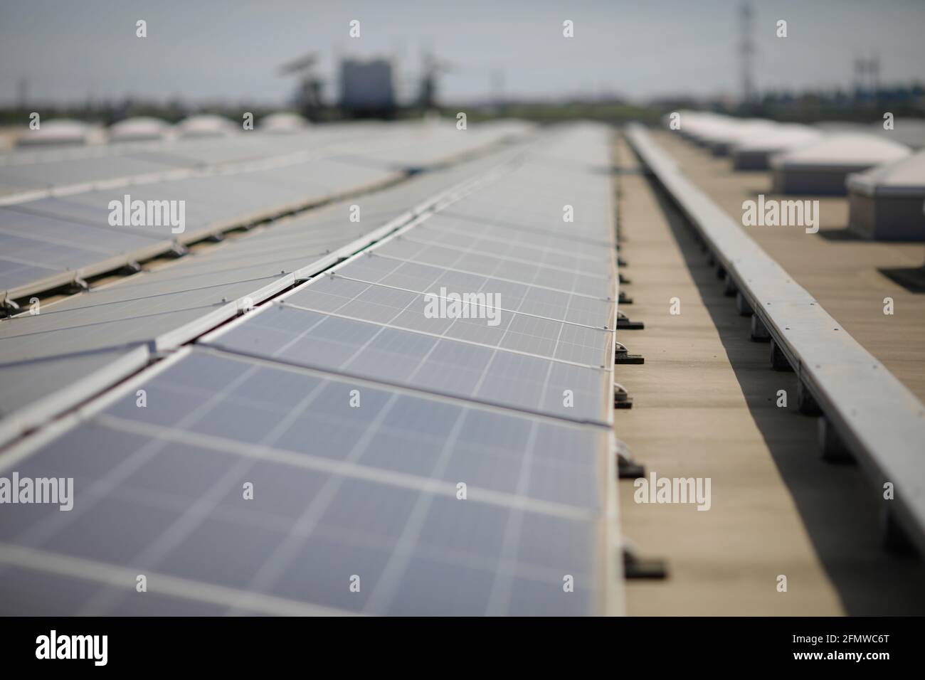 Industrial solar panels on the roof of a hypermarket. Stock Photo