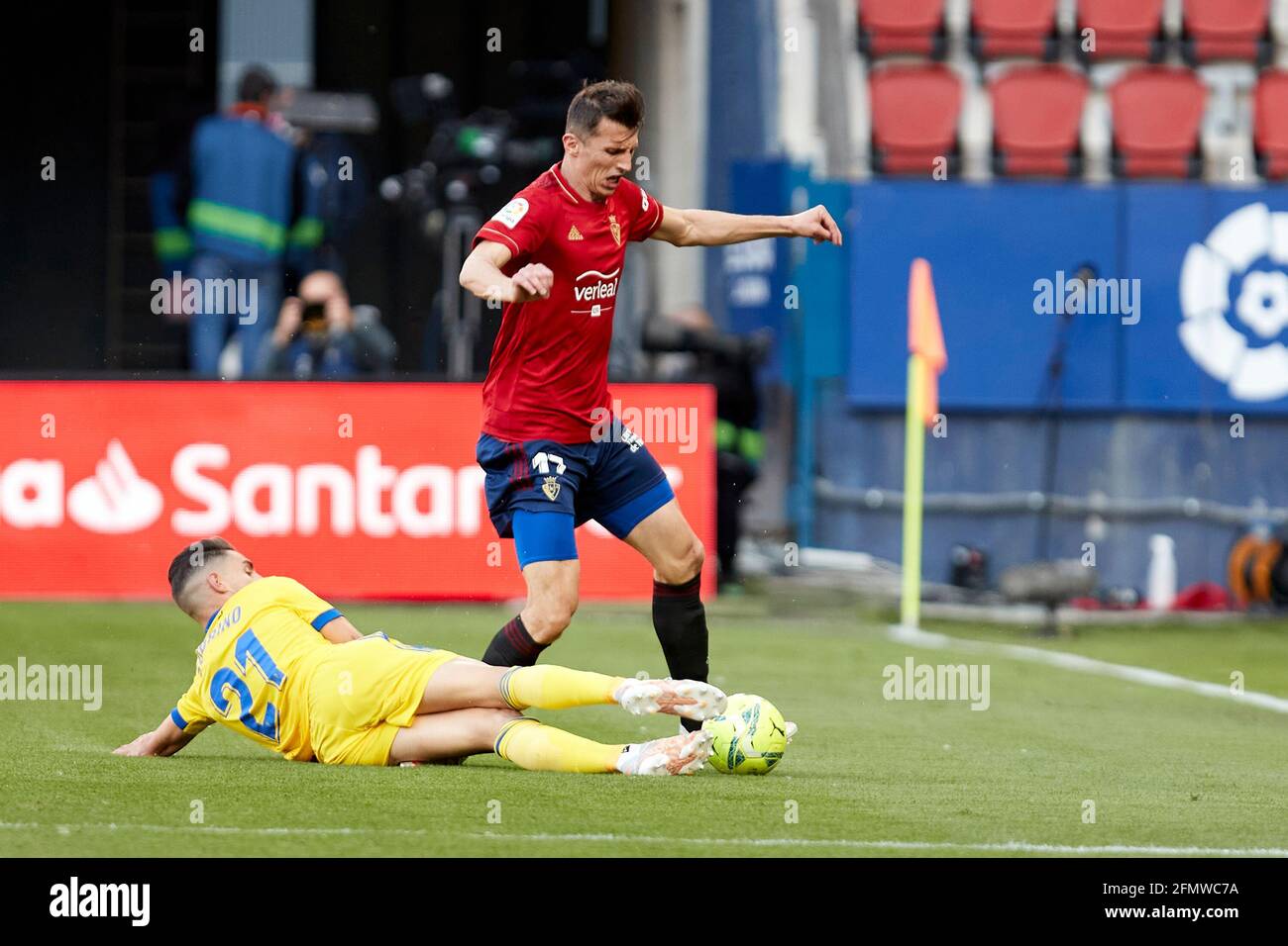 Pamplona, Spain. 11th May, 2021. Rubén Sobrino Pozuelo (forward; Cádiz CF) and Budimir (forward; CA Osasuna) in action during the Spanish La Liga Santander match between CA Osasuna and Cádiz CF at the Sadar stadium.(Finale Score; CA Osasuna 3-2 Cádiz CF) Credit: SOPA Images Limited/Alamy Live News Stock Photo