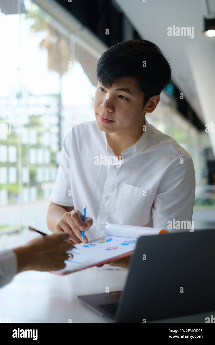 Businessman using pencil and working on desk in home office. Consultant