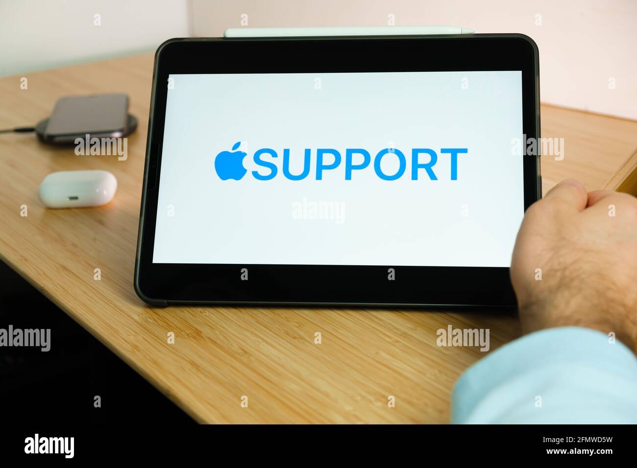 Apple support logo on the screen of iPad tablet. March 2021, San