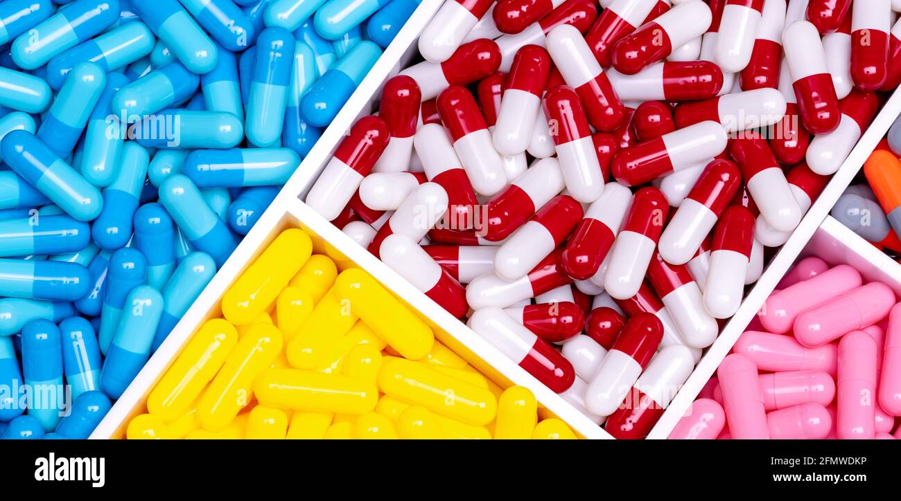 Antibiotic drugs. Top view of painkiller capsule pills and supplements capsule in plastic tray. Pharmaceutical industry. Pharmacy banner. Prescription Stock Photo