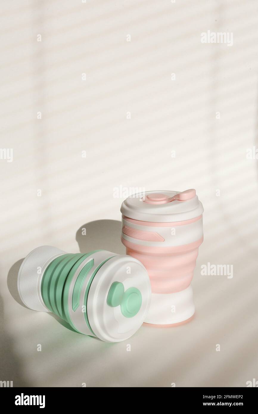 Stylish reusable eco coffee cup on white background. Ban single use