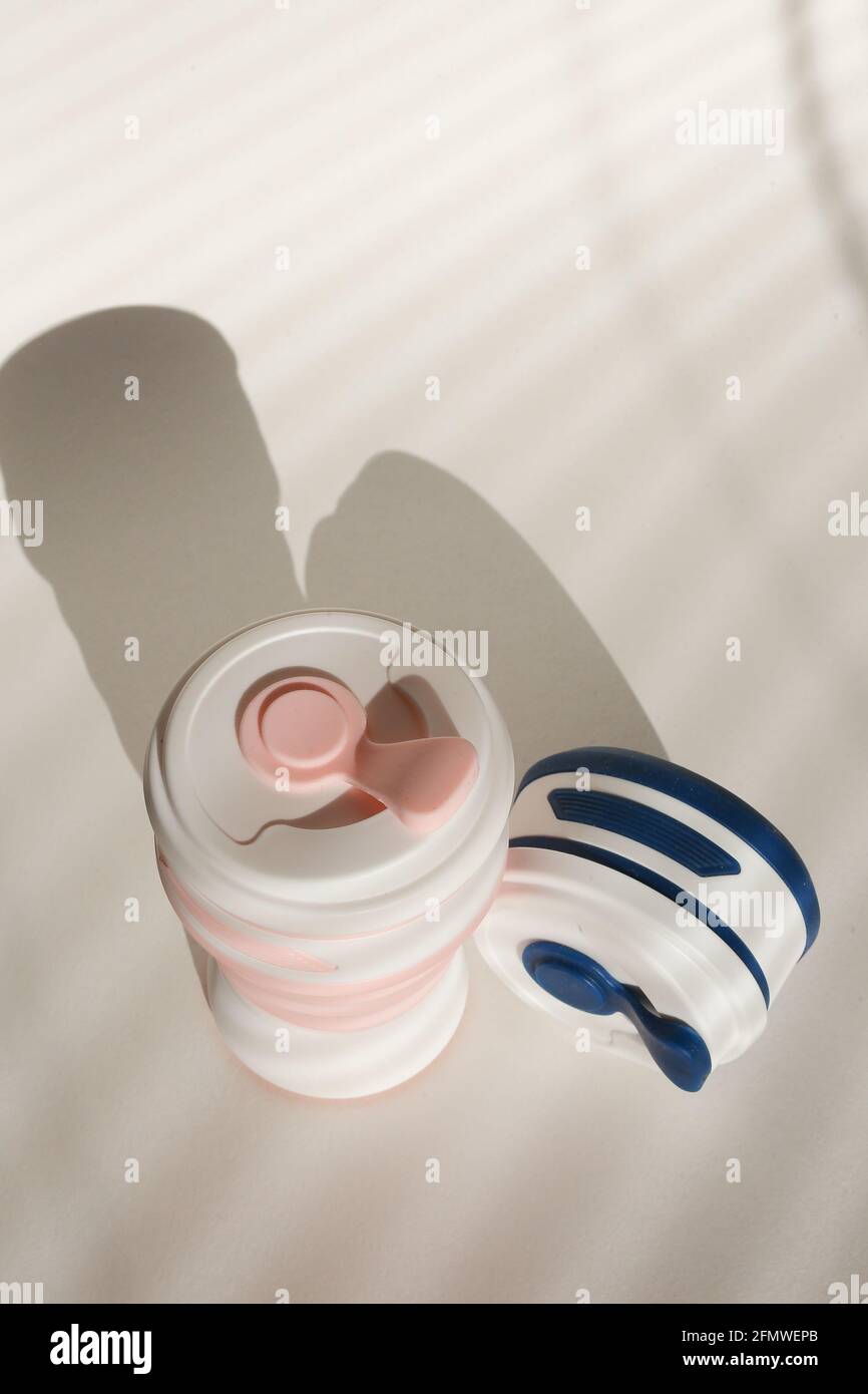 Stylish reusable eco coffee cup on white background. Ban single use