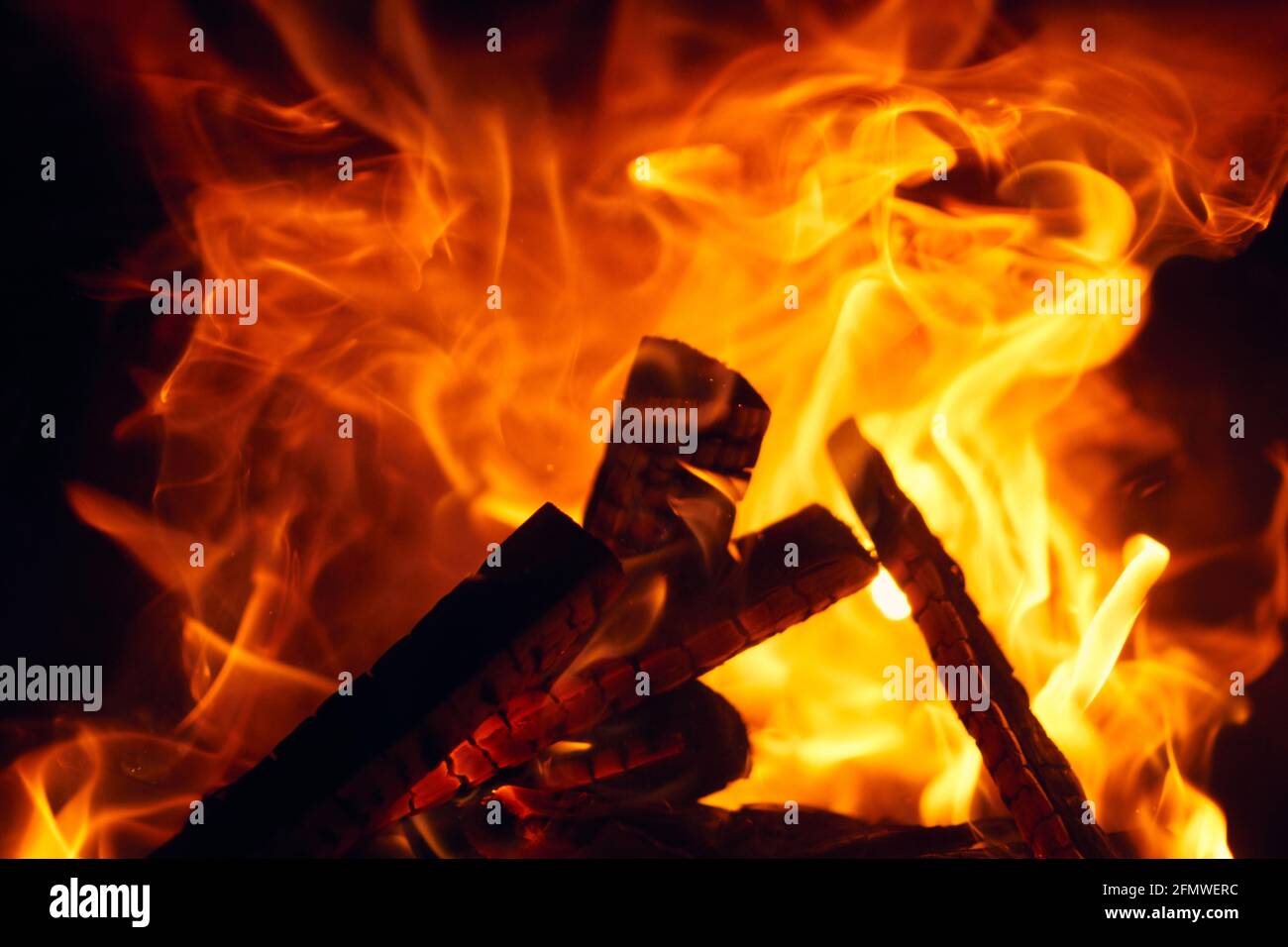 A fire burns in a fireplace, Fire to keep warm. Logs burning in Stock