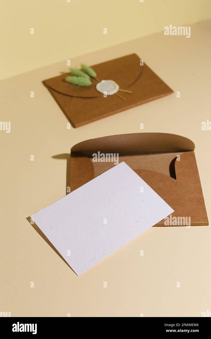 Brown Envelope with empty letter for yur text on beige background Stock Photo