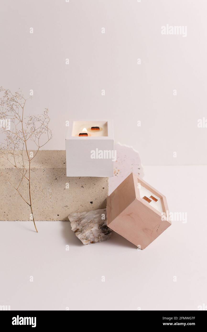 scented candles on off white background in rock holder Stock Photo - Alamy