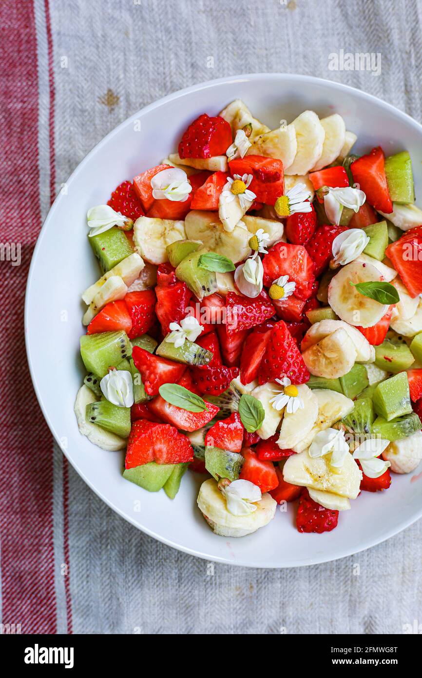 Fruit salad with acacia flowers Stock Photo
