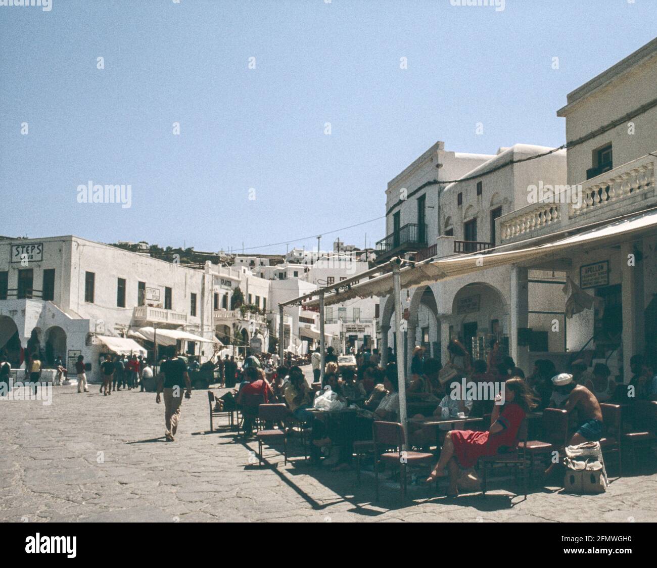 Scanned image   Coffe takes over from alchohol on the seafront at the Greek Island of Mykonos, part of the Cyclades, popular with back packers in the Stock Photo