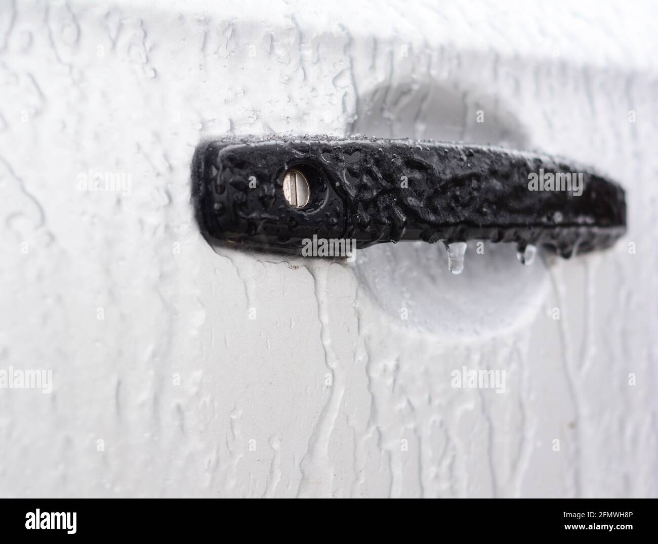 Ice damage to a car lock. How to de-ice the car and open, unlock frozen car doors. Stock Photo