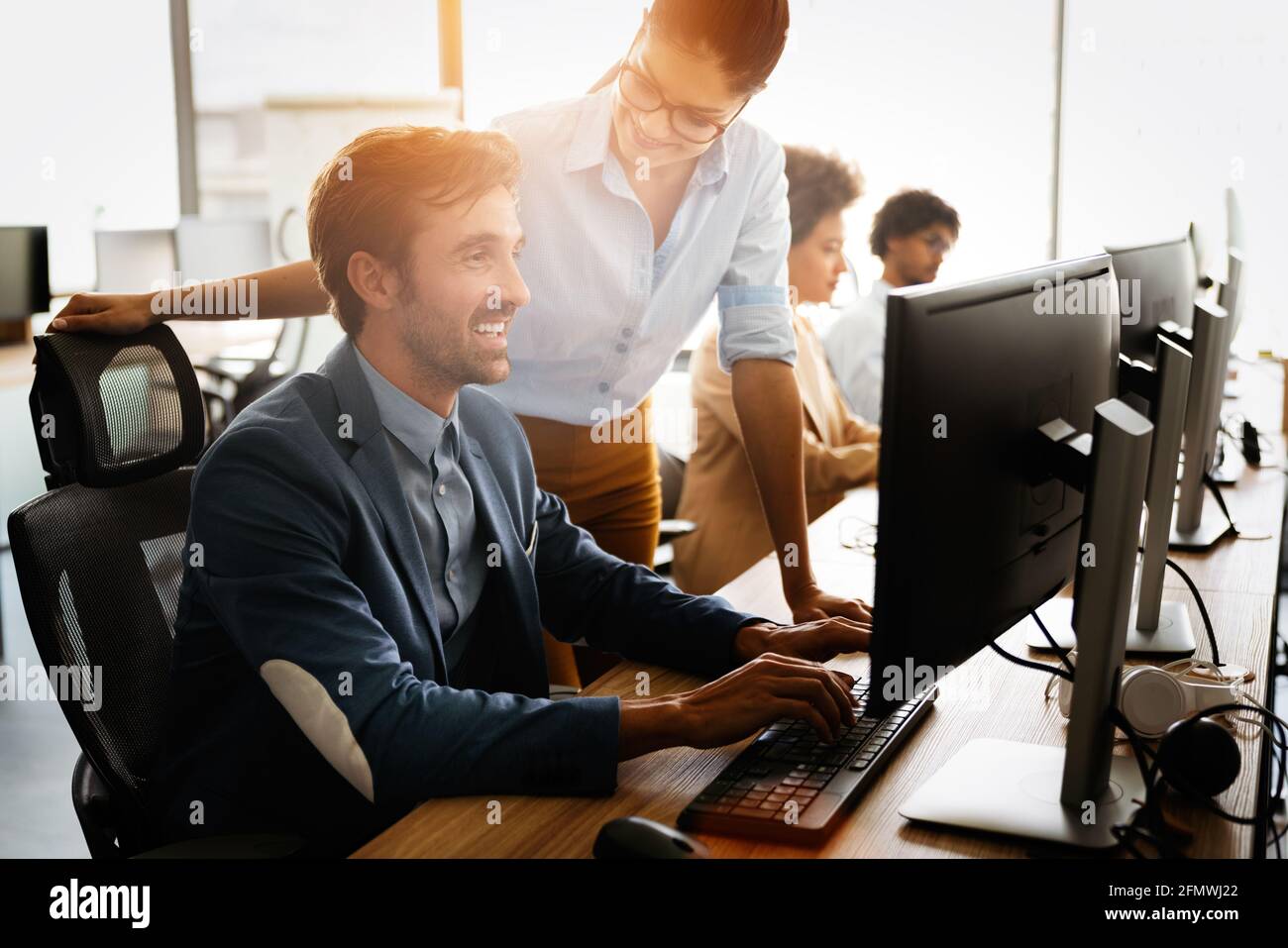 Programmers cooperating brainstorming at information technology company ...