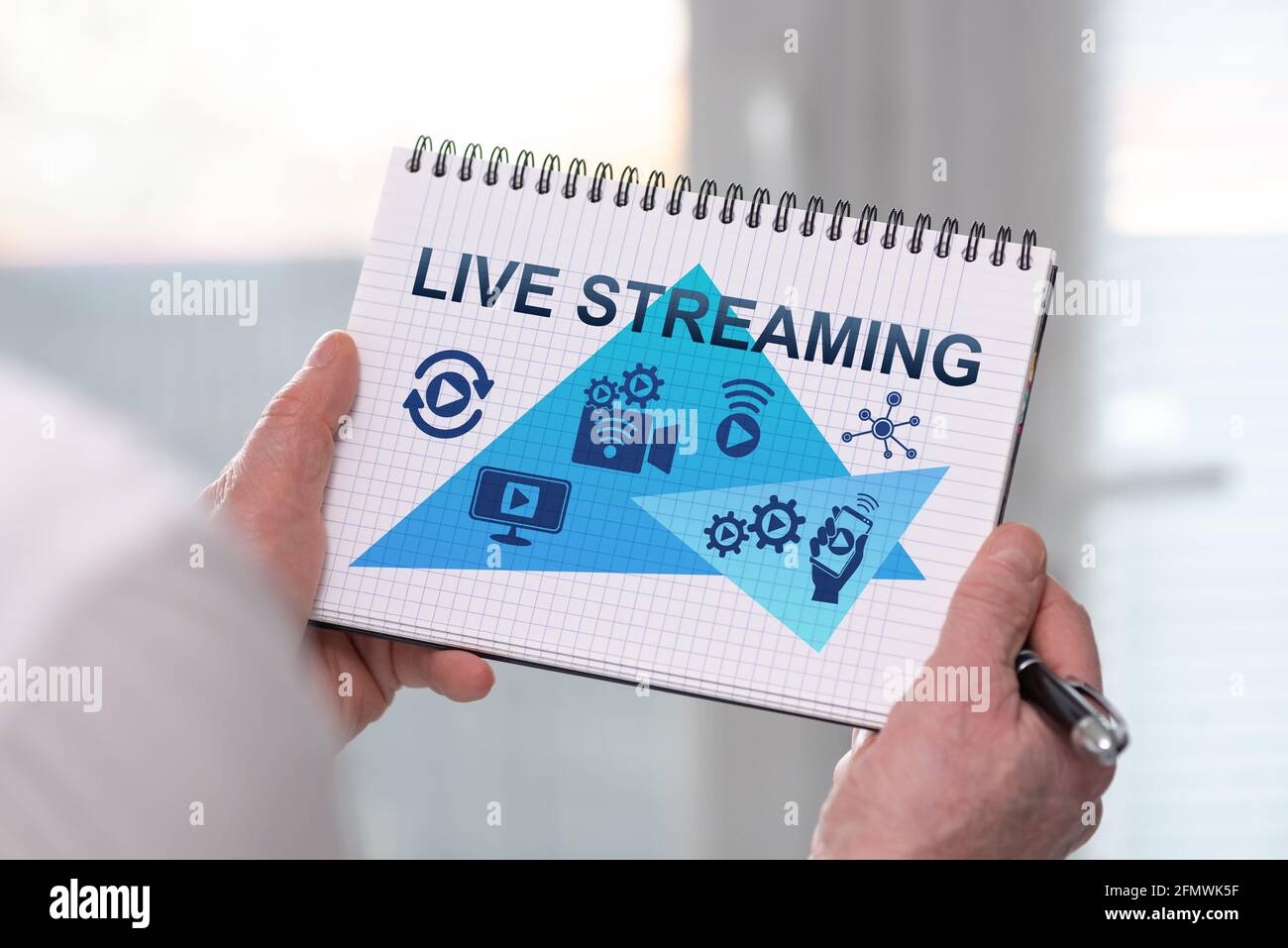 Live Notepad Hand holding a notepad with live streaming concept Stock Photo - Alamy