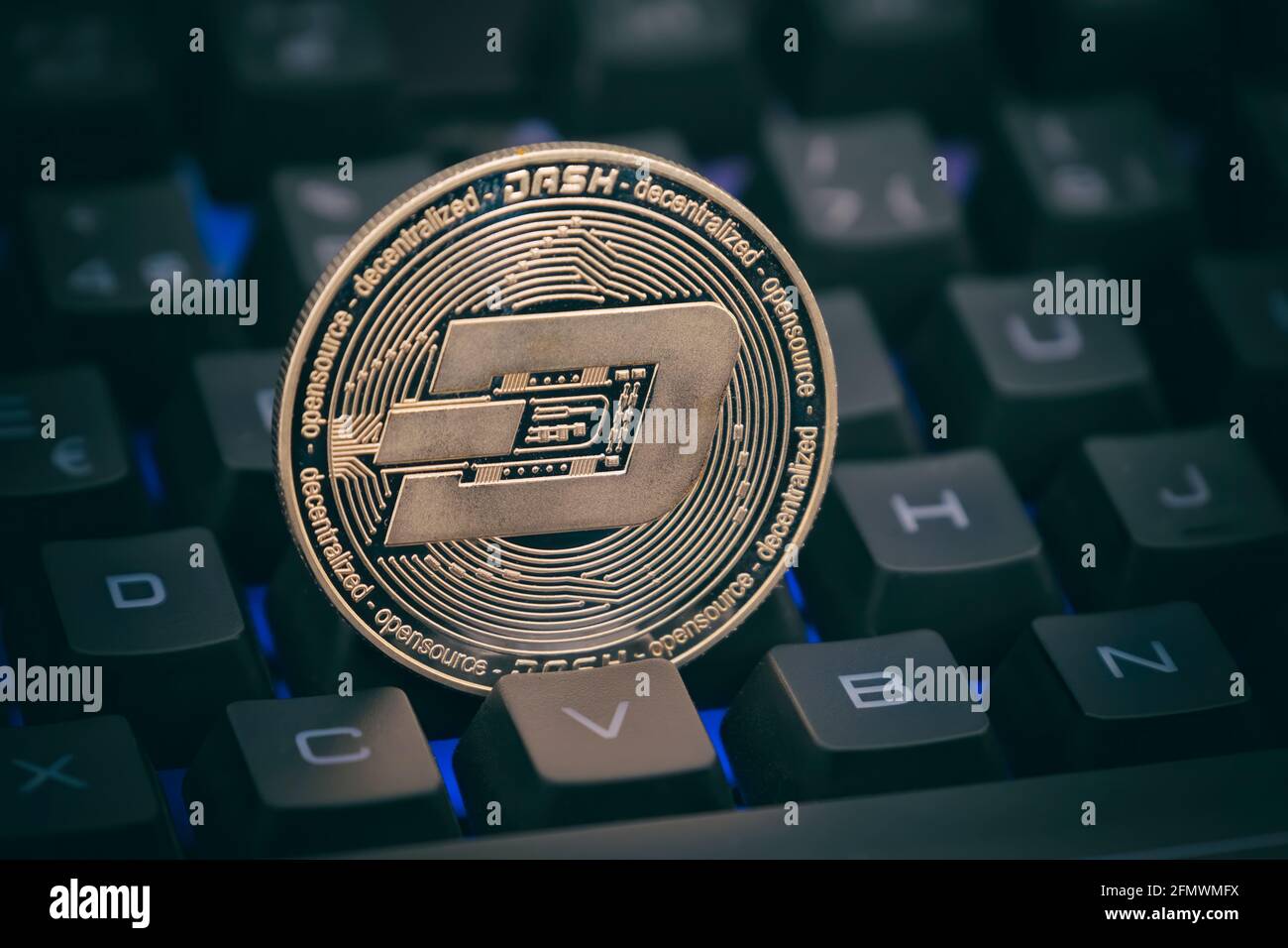 Physical Dash Coin Between The Keys Of A Computer Keyboard Stock Photo