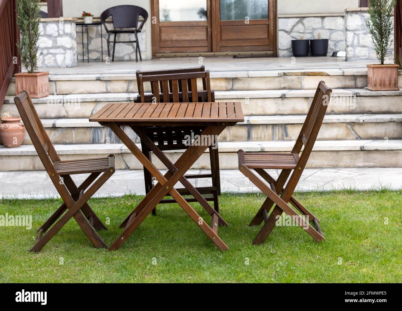 wooden table and chairs on the garden lawn Stock Photo - Alamy
