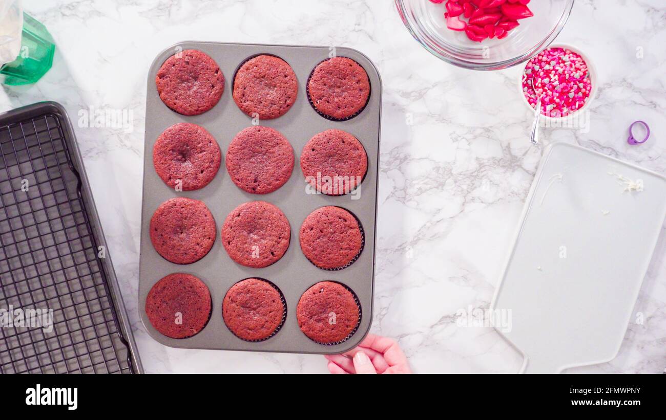 Flat lay. Step by step. Cooling red velvet cupcakes on a kitchen drying rack. Stock Photo