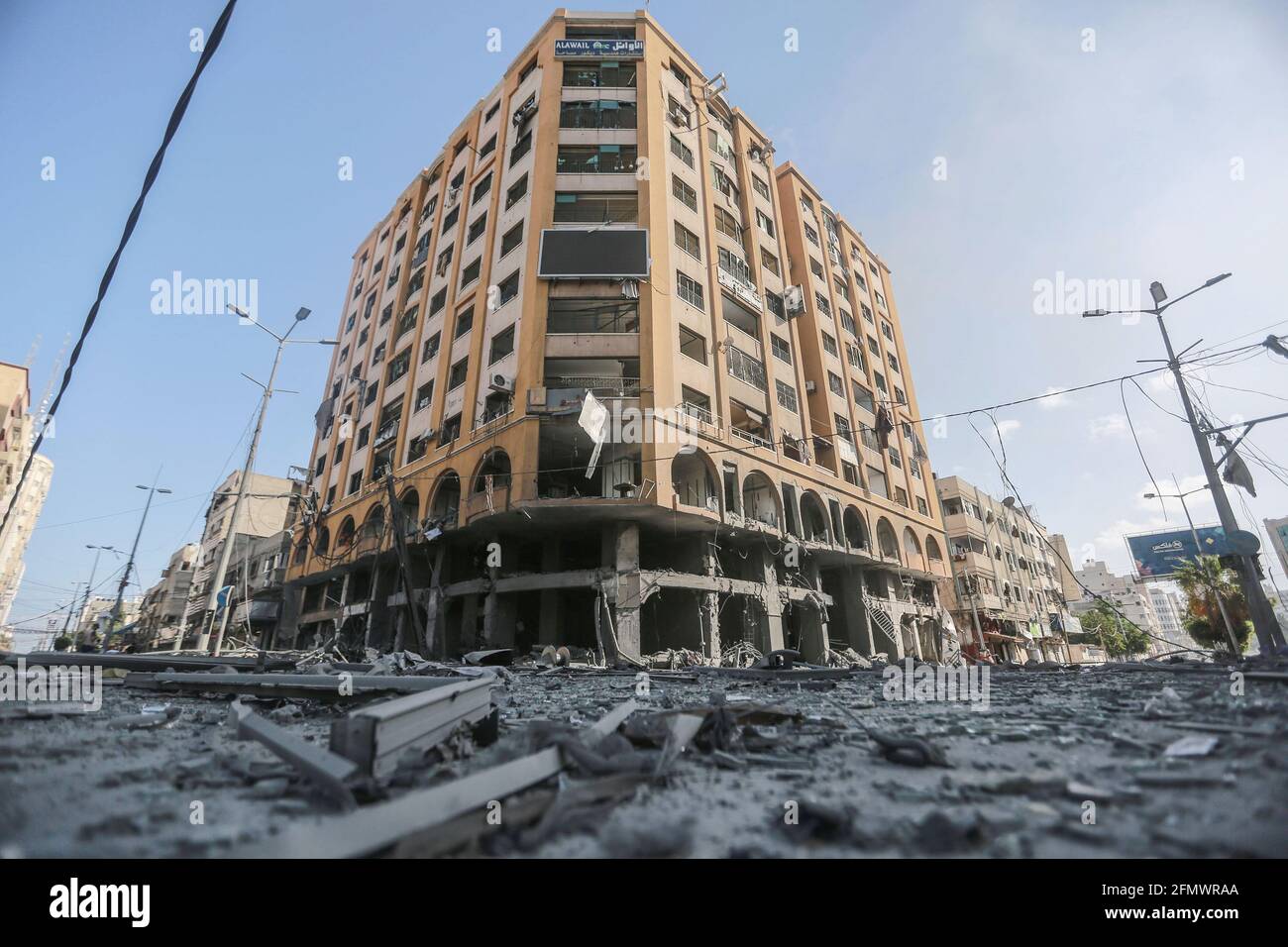 Gaza City, Palestinian Territories. 12th May, 2021. A general view of the severely damaged Al-Jawhara Tower area in Gaza City after it was hit by Israeli airstrikes amid the escalating flare-up of Israeli-Palestinian violence. The Health Ministry in the Hamas-run Gaza Strip said the number of Palestinians killed has risen to 35, including 12 children, while 233 people were reported injured. Credit: Mohammed Talatene/dpa/Alamy Live News Stock Photo