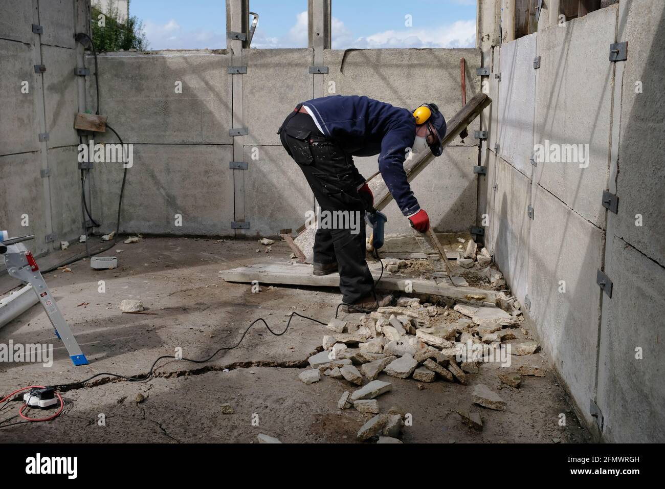 A man dismantling his old garage. Stock Photo