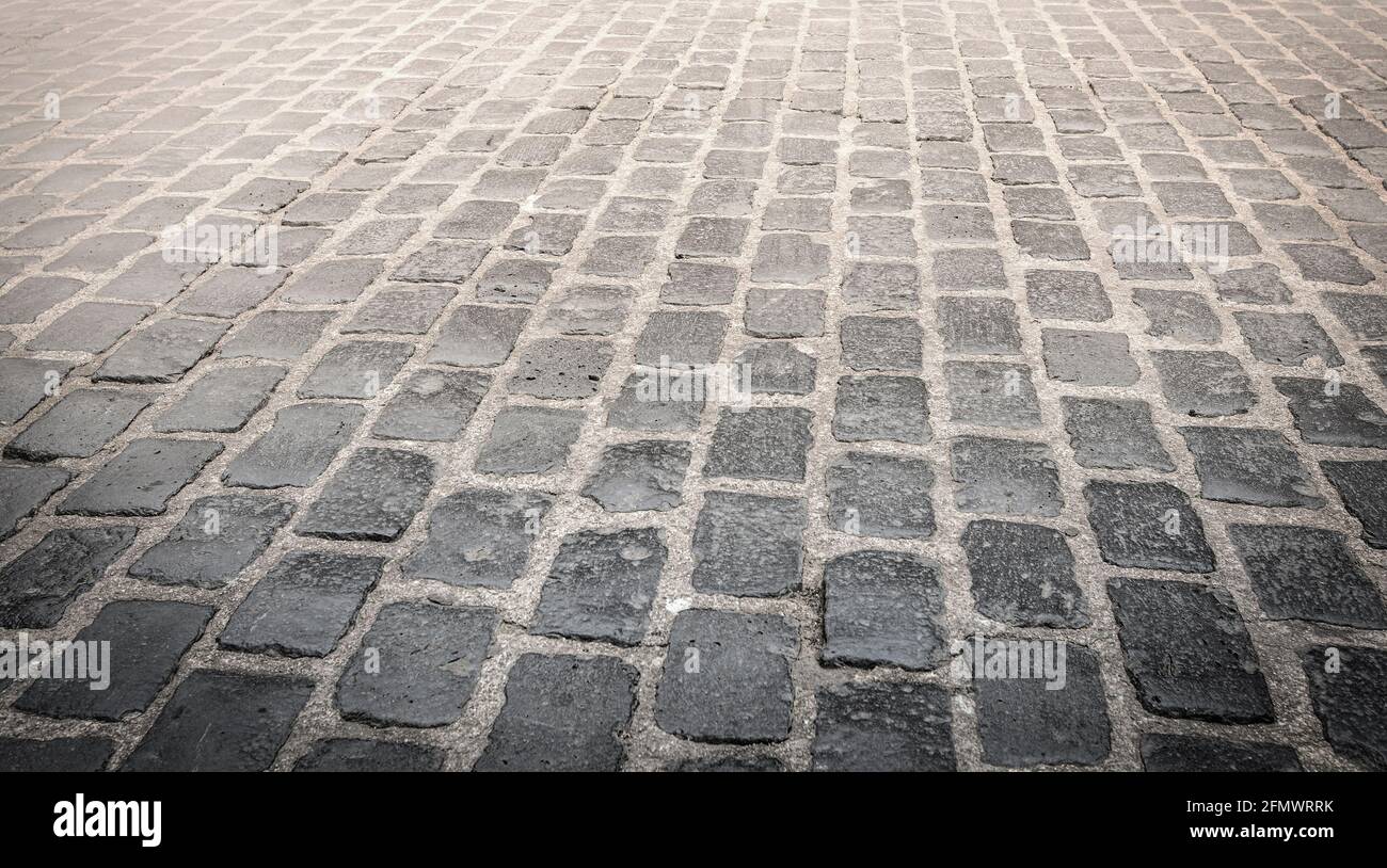 The Granite cobblestoned pavement background. Selective focus Stock Photo