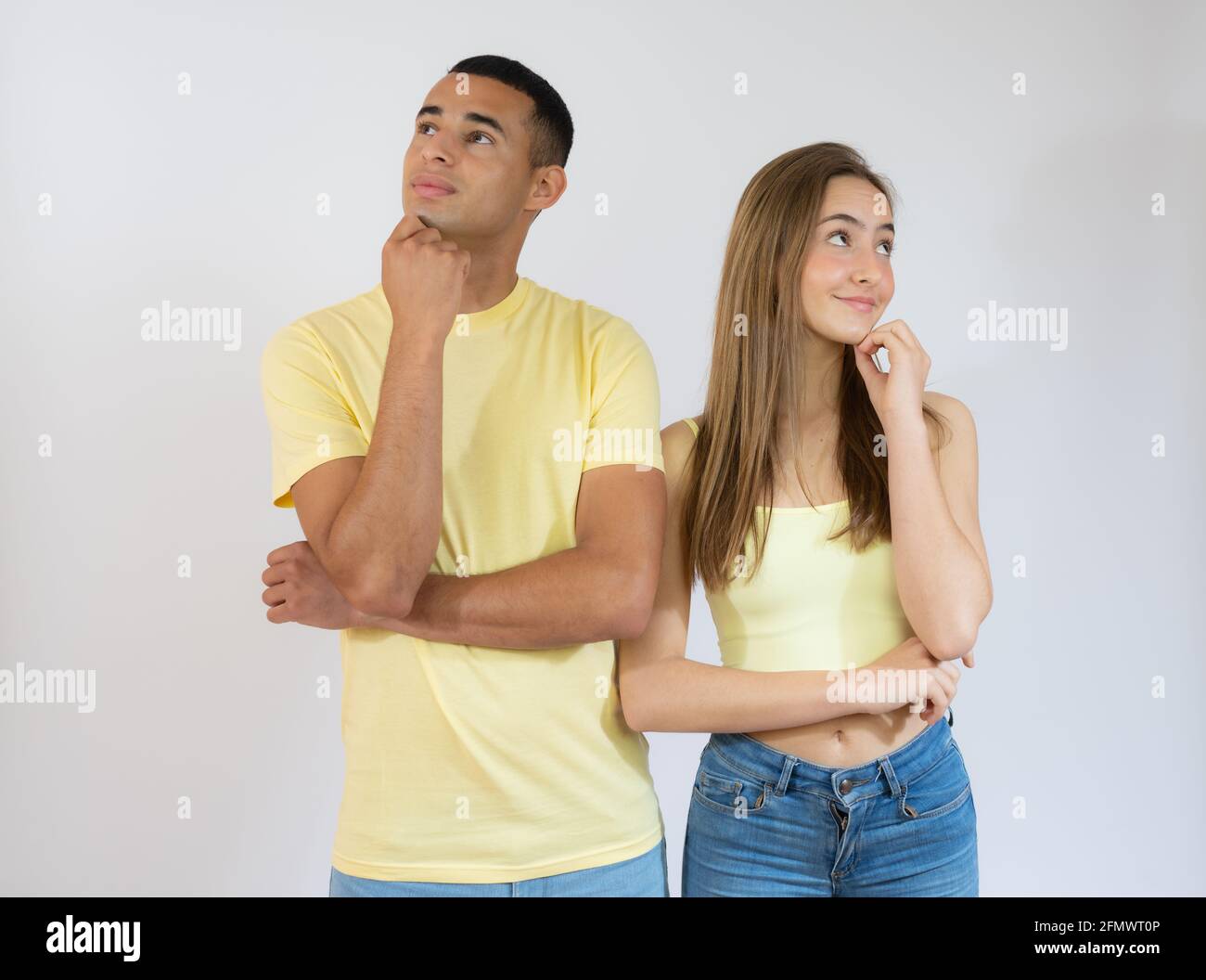 Beautiful young couple of boyfriend and girlfriend together confuse and wonder about question. Pensive concept. Stock Photo