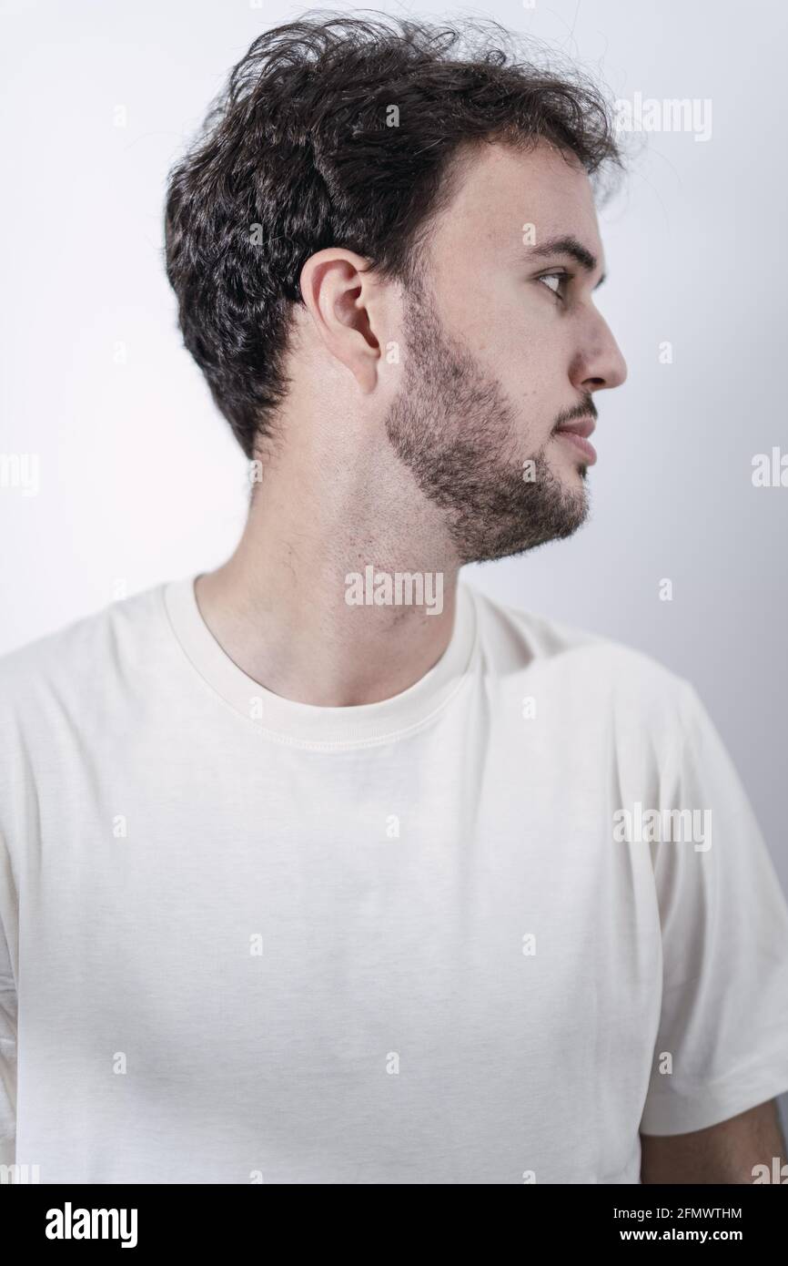 The side profile of a bearded Caucasian man in white shirt against a white  background Stock Photo - Alamy