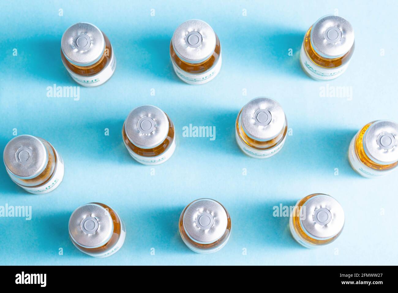 pattern from a vial with a coronavirus vaccine on a blue background ...