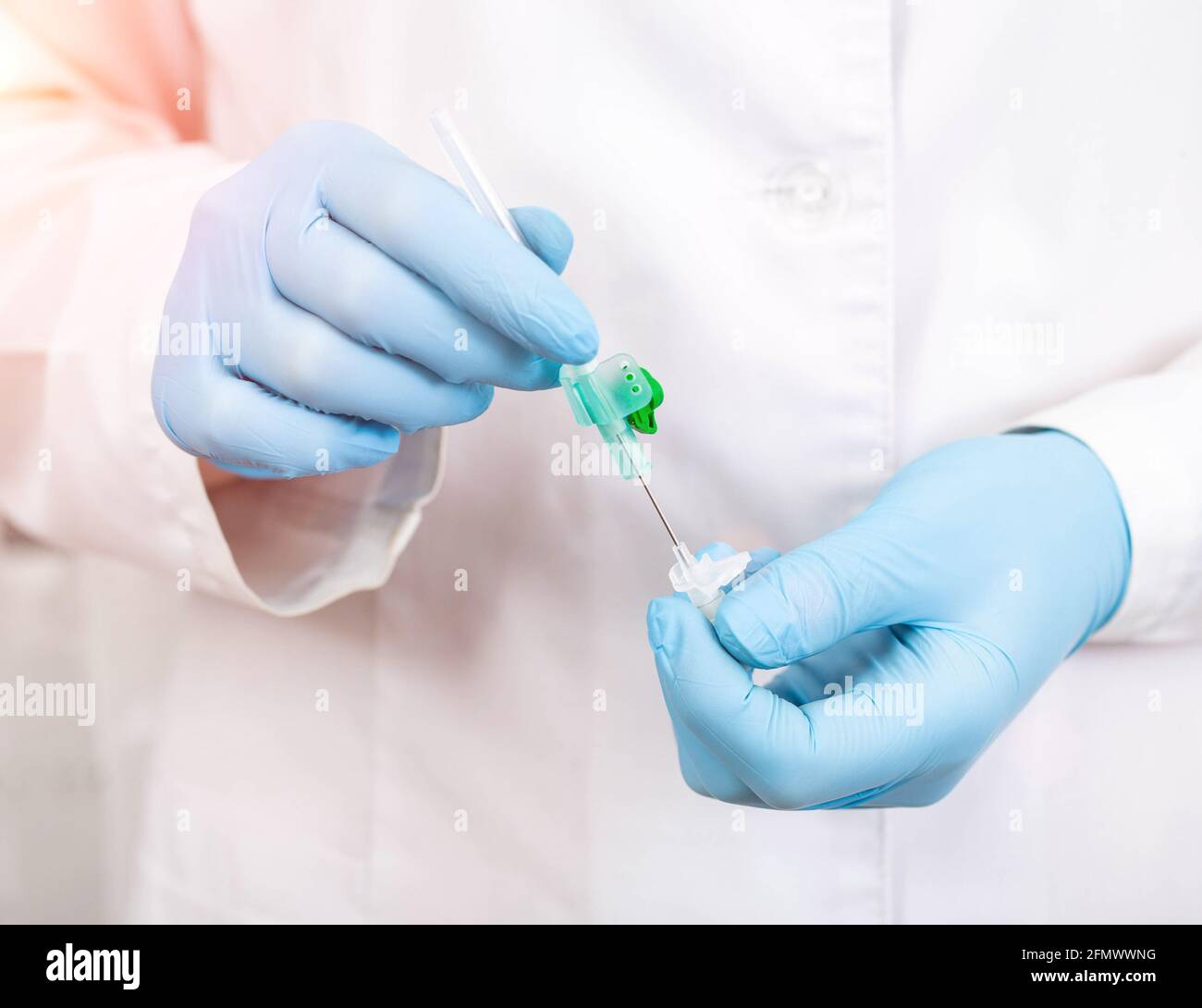 Doctor holds a cannula in his hands which is used in cosmetology and dentistry, close-up, medical procedure Stock Photo