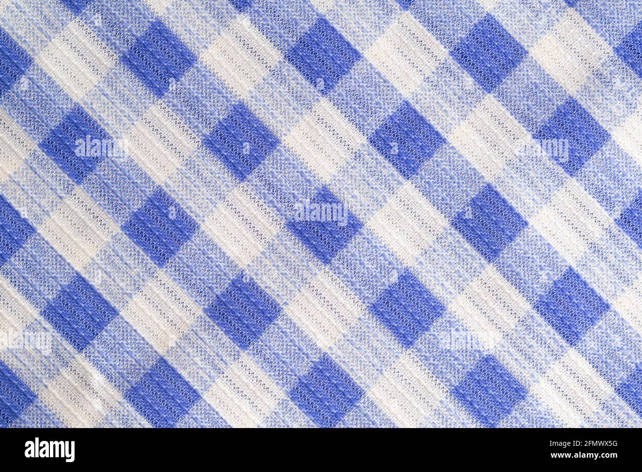 Blue kitchen material in a cage, tablecloth on the table, background. Macro, textured Stock Photo