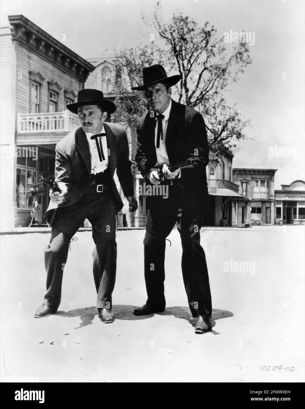 KIRK DOUGLAS as Doc Holliday and BURT LANCASTER as Wyatt Earp in GUNFIGHT AT THE O.K. CORRAL 1957 director JOHN STURGES screenplay Leon Uris music Dimitri Tiomkin producer Hal B. Wallis  Wallis-Hazen / Paramount Pictures Stock Photo