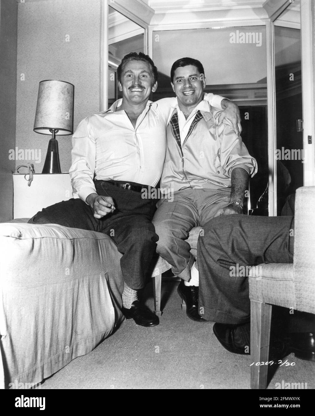KIRK DOUGLAS with visitor JERRY LEWIS in his Dressing Room during filming of GUNFIGHT AT THE O.K. CORRAL 1957 director JOHN STURGES screenplay Leon Uris music Dimitri Tiomkin producer Hal B. Wallis  Wallis-Hazen / Paramount Pictures Stock Photo