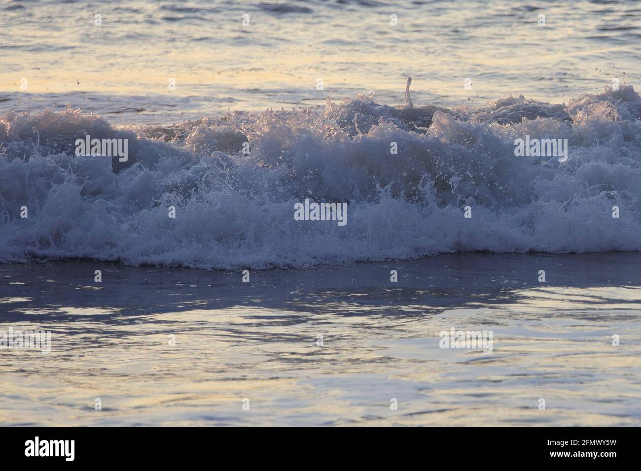 Waves breaking on the beach Stock Photo - Alamy