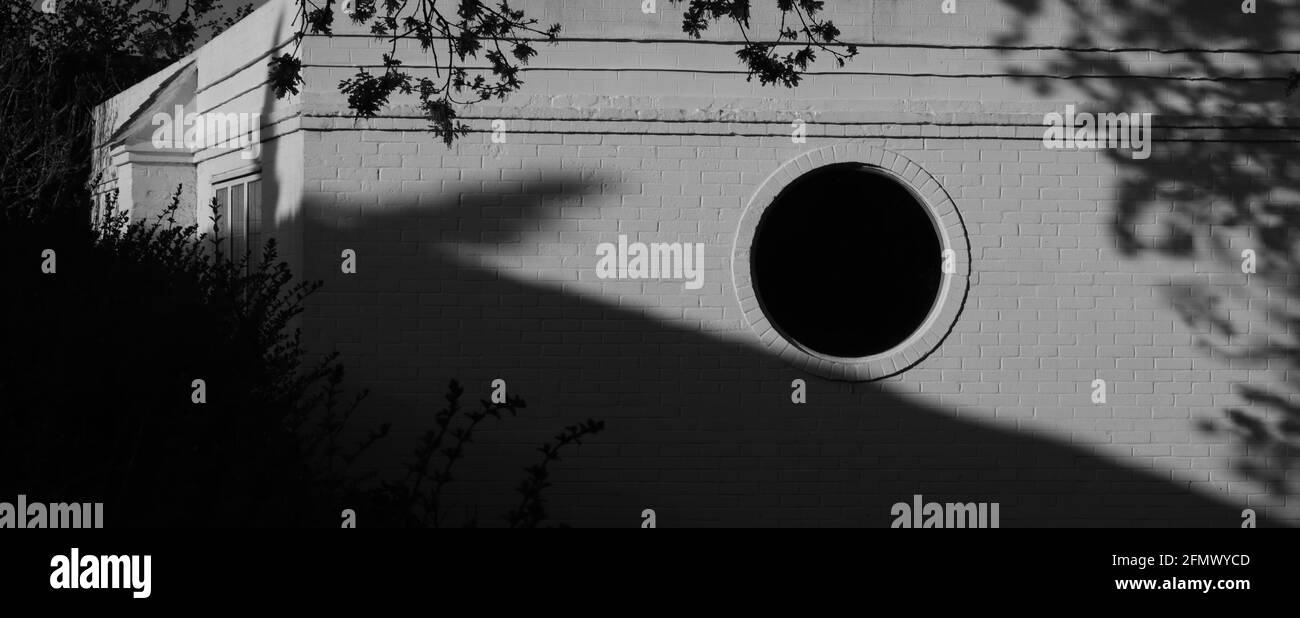 Black round window on a white wall, UK Stock Photo - Alamy