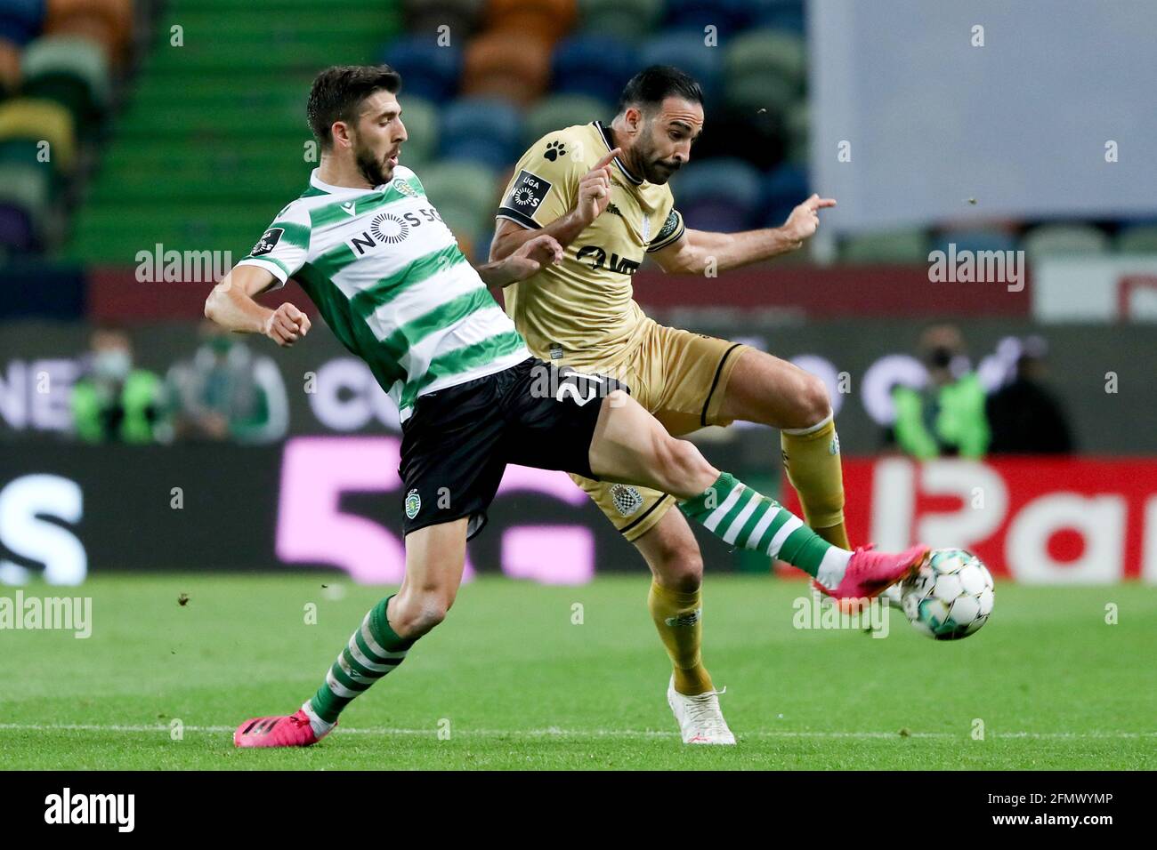 Lisbon. 11th May, 2021. Paulinho (L) of Sporting CP vies with Adil Rami of Boavista FC during a Portuguese League football match at Jose Alvalade stadium in Lisbon, Portugal on May 11, 2021. Credit: Pedro Fiuza/Xinhua/Alamy Live News Stock Photo