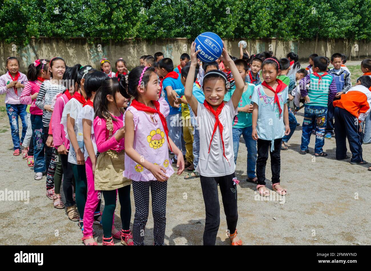 Students in a rural school in Qufu, Shandong, China having a friendly competition with over and under game. Stock Photo