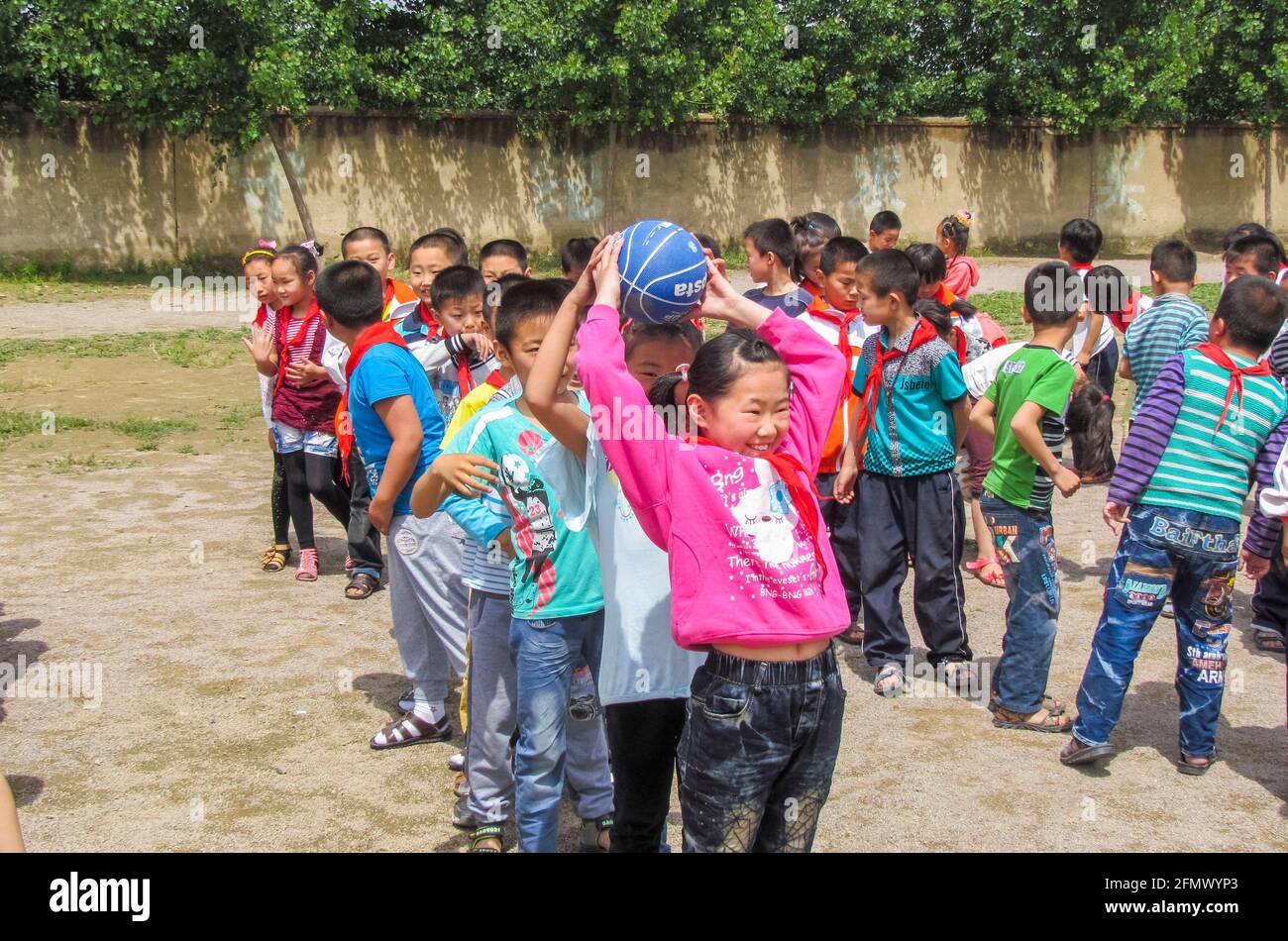 Students in a rural school in Qufu, Shandong, China having a friendly competition with over and under game. Stock Photo